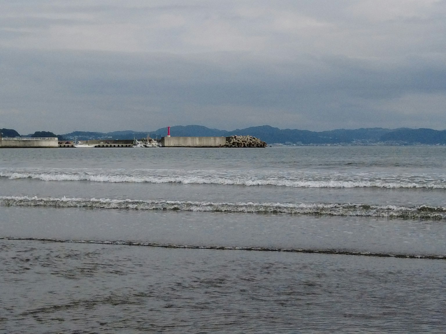 Scène côtière avec vagues et ciel nuageux