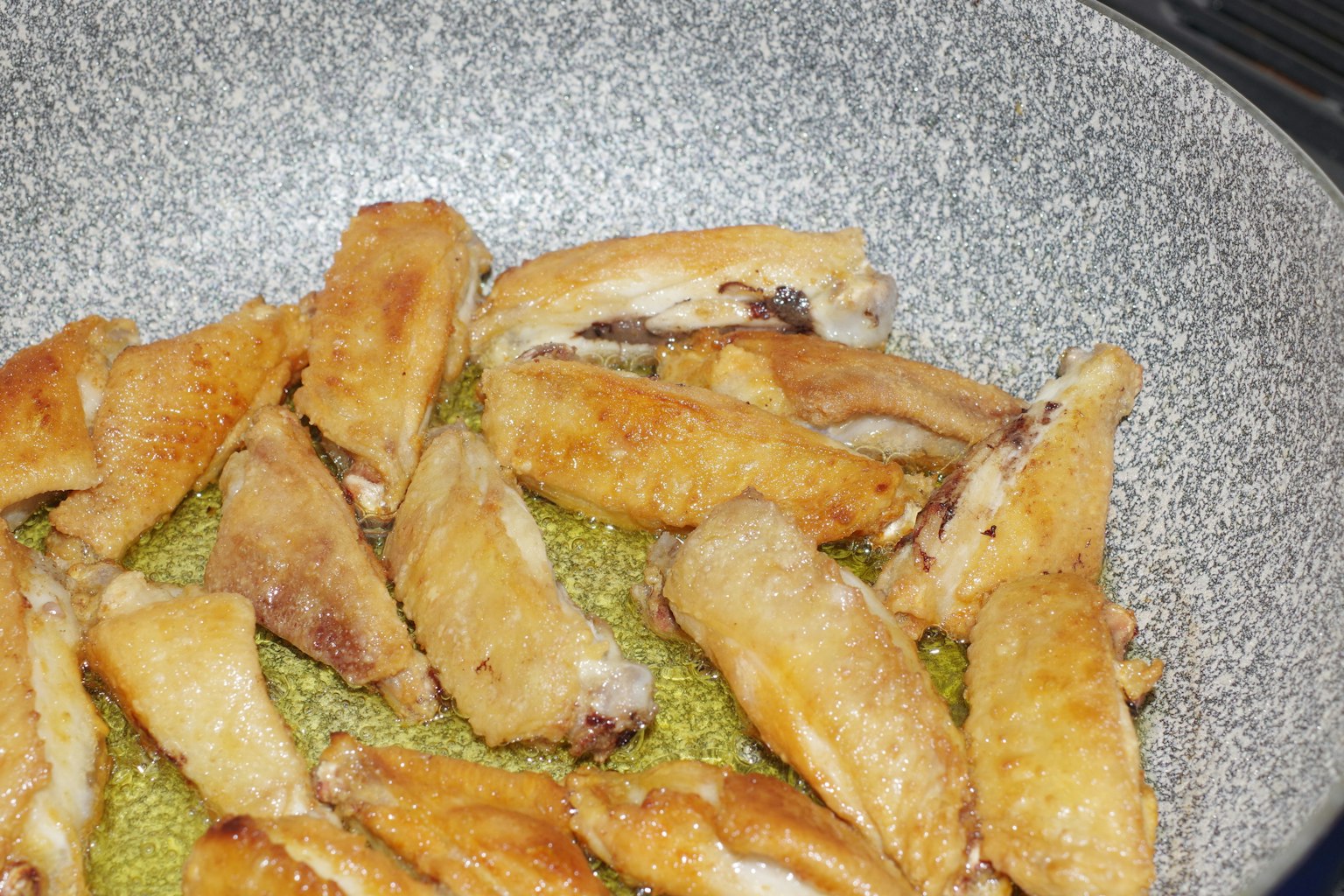 Fried chicken wings arranged in a silver pan