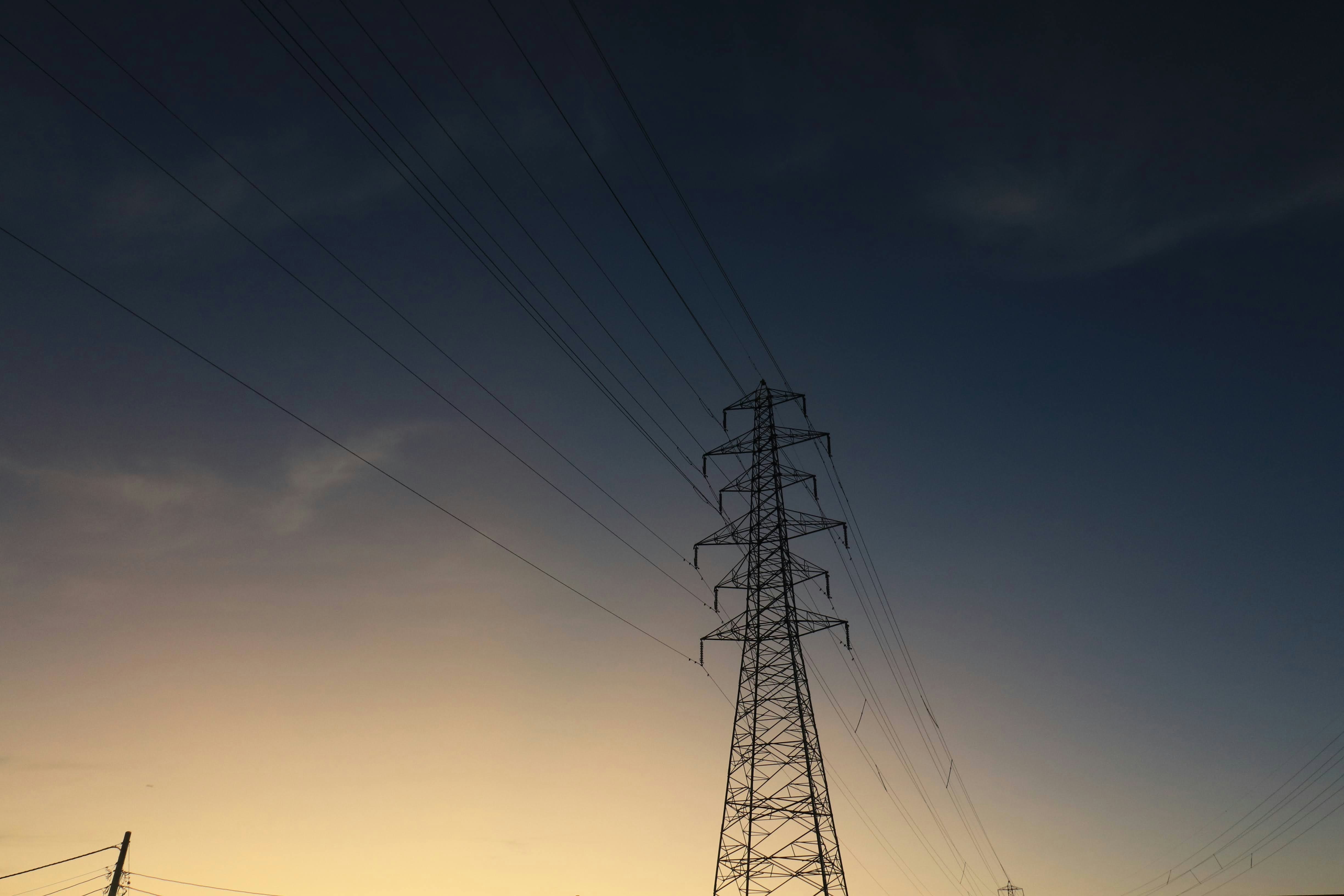 power transmission tower and overhead lines at dusk