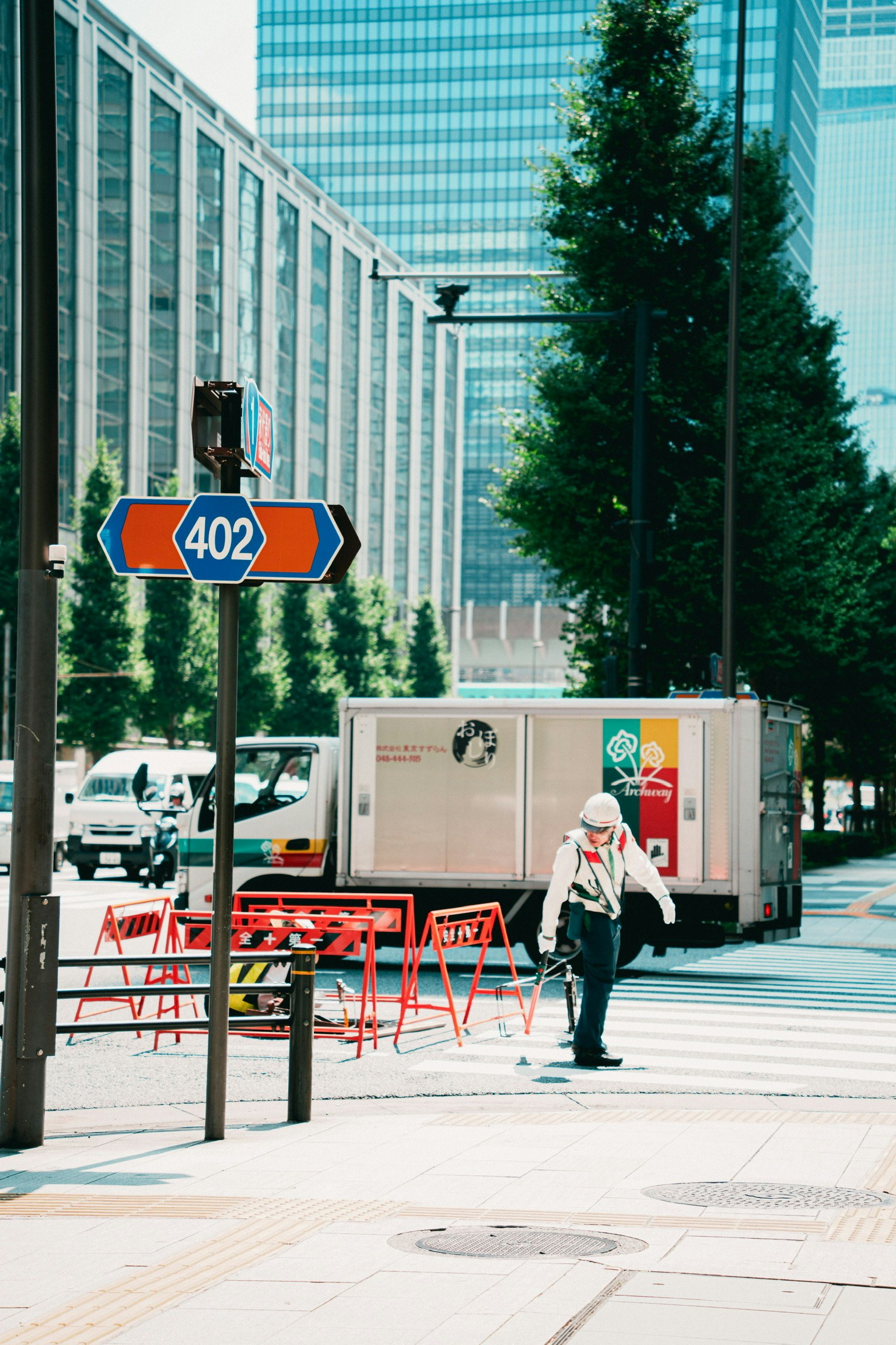 signage and outdoor chairs along a sidewalk in a business district