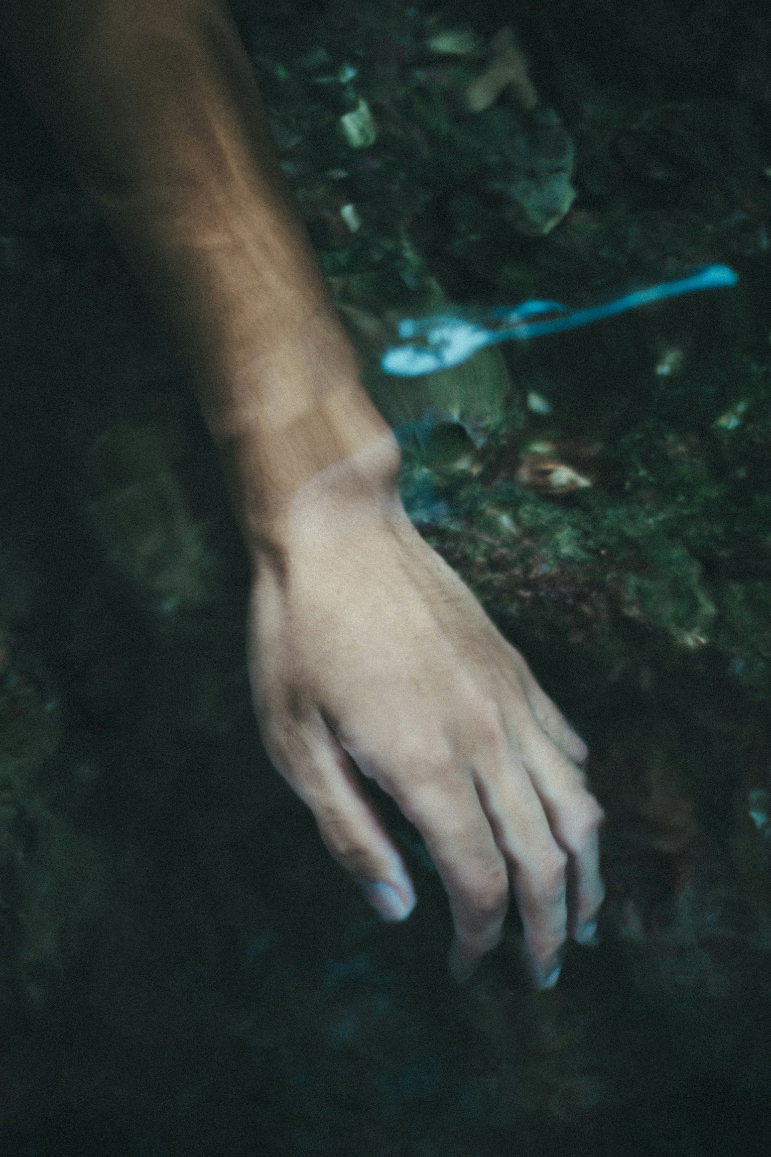 Image of a hand reaching out in water evoking tranquility in nature