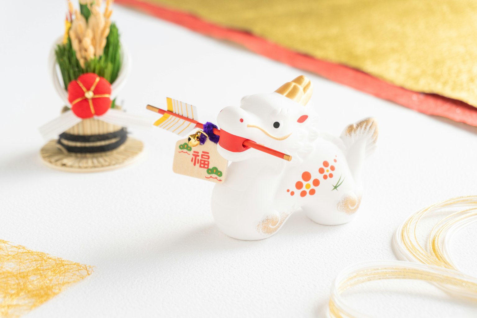 White ceramic dog figurine with an arrow and decorative elements in the background
