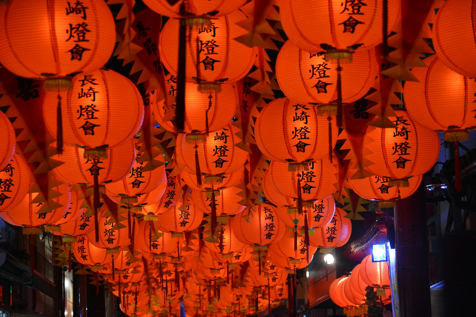 A vibrant display of red lanterns hanging in the night sky