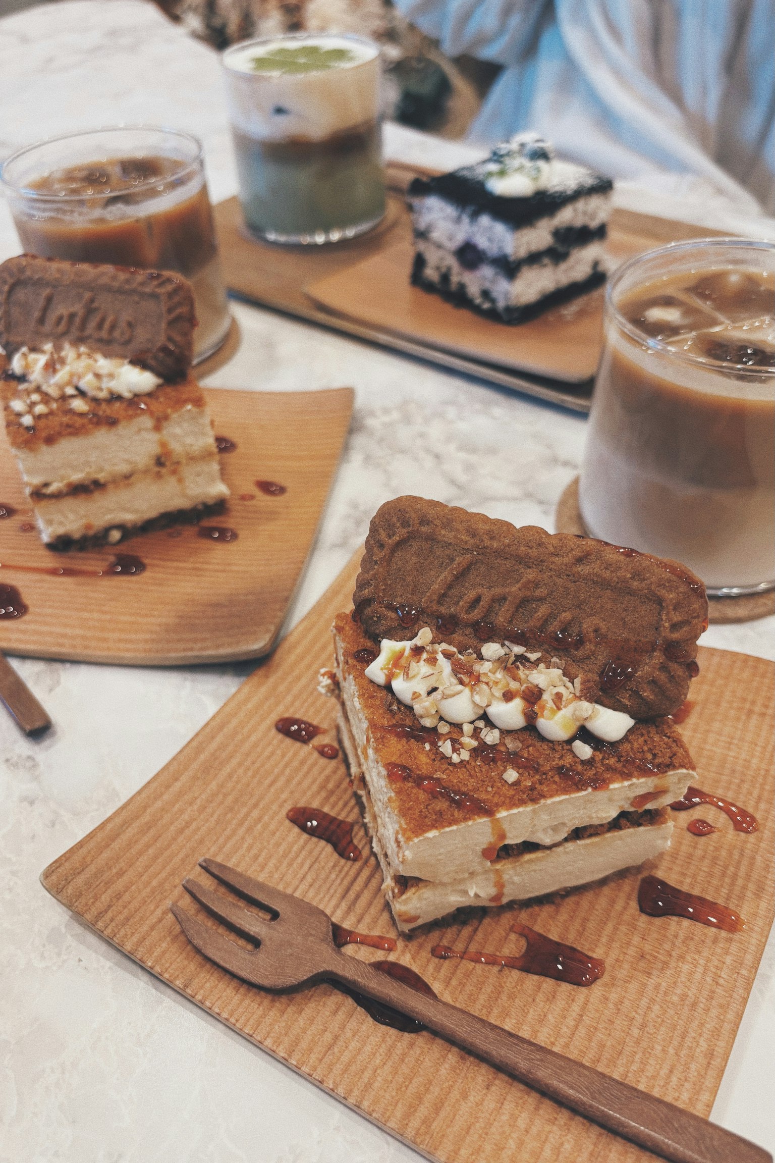 Tiramisu-style cake with chocolate and coffee drinks on wooden plates