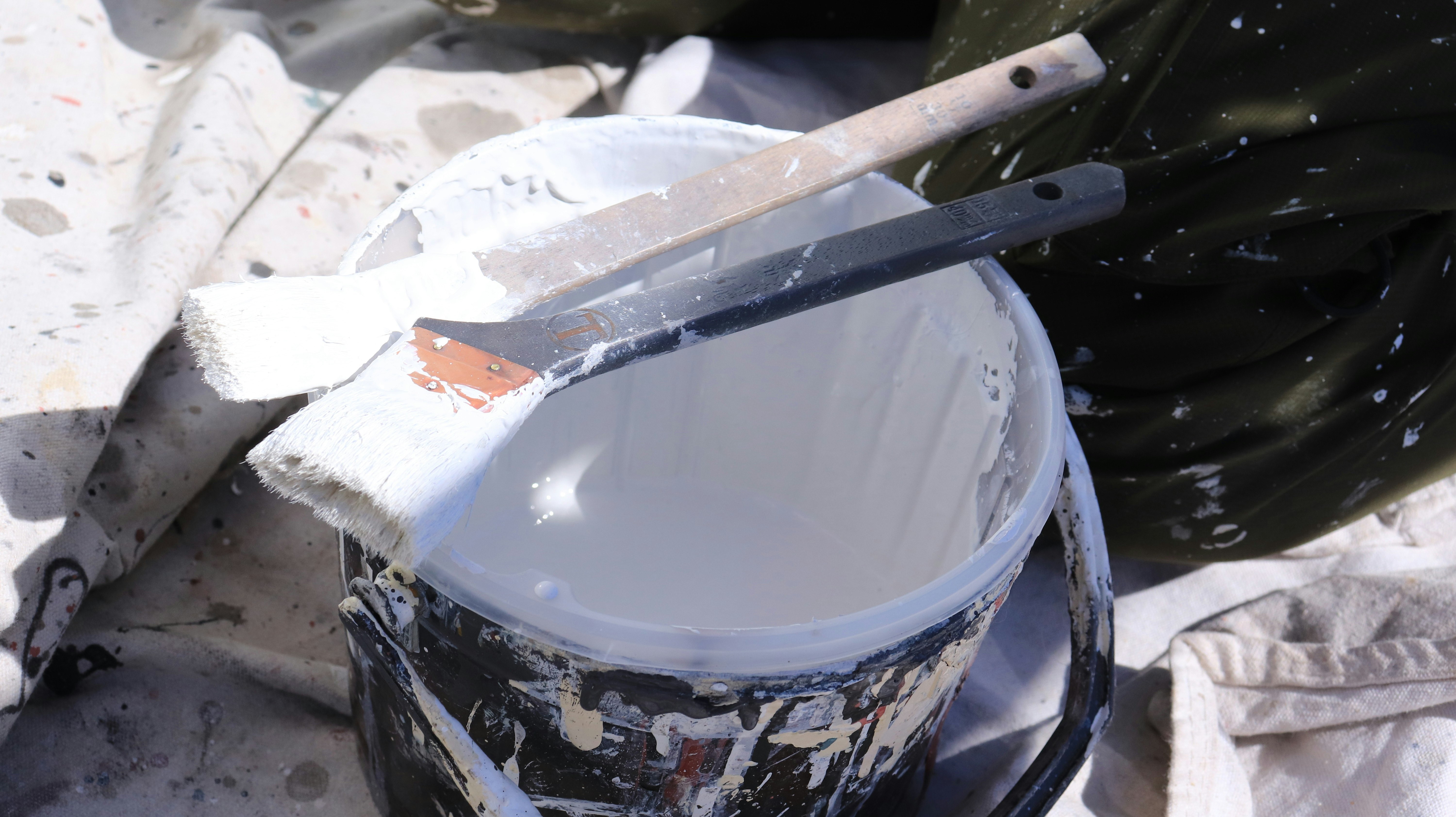 paint bucket and roller on a worksite