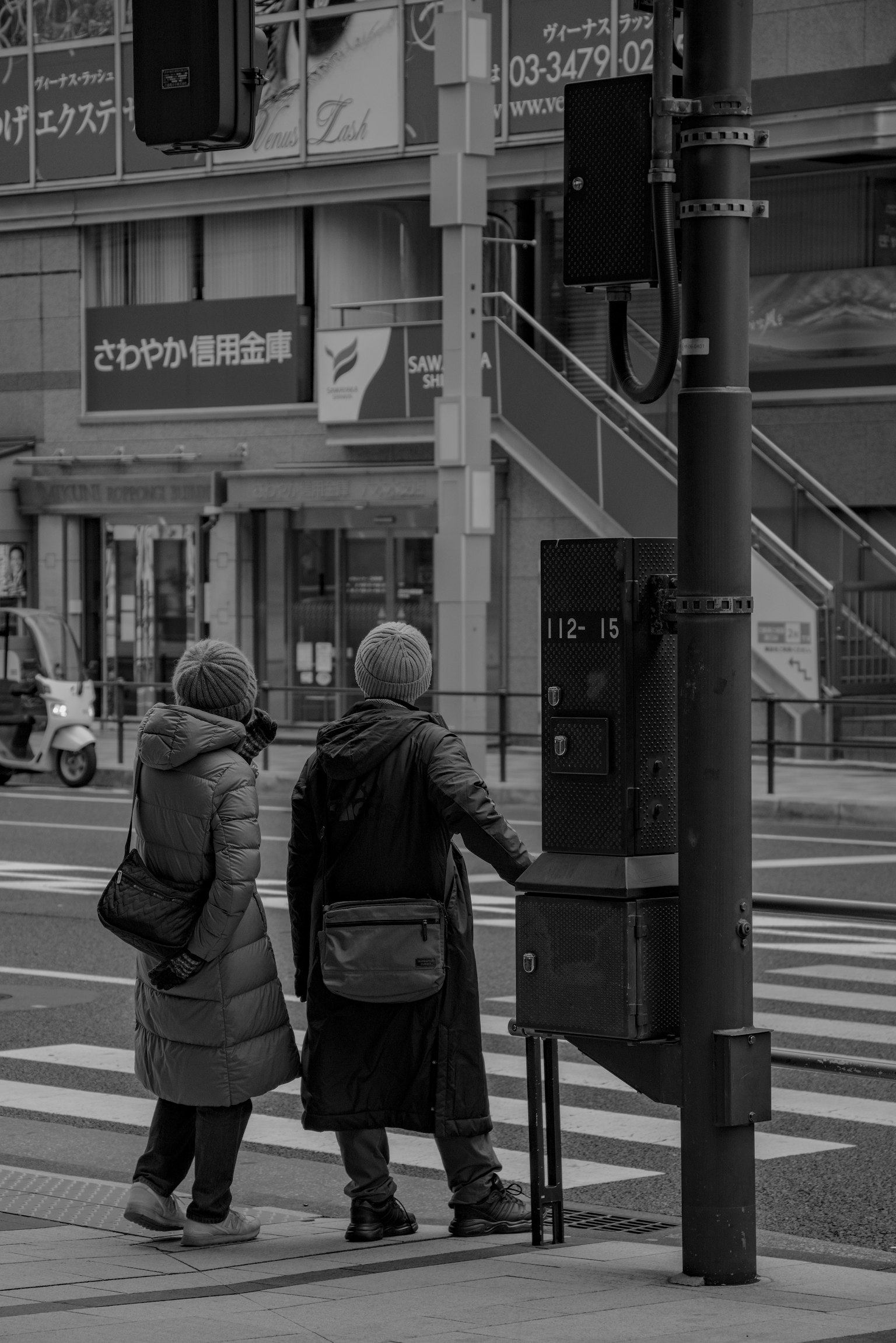Due donne in attesa al semaforo in bianco e nero
