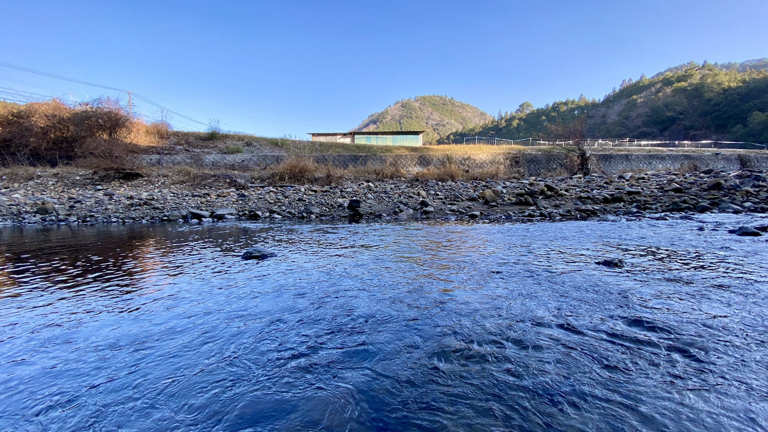 Scenic view of a blue river with mountains in the background