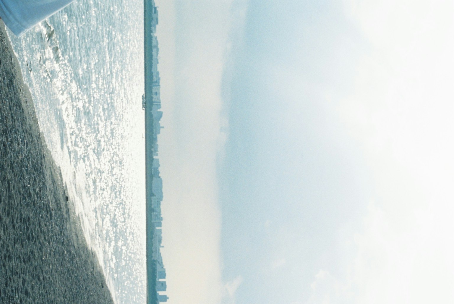 A serene beach scene with calm waves and a bright sky