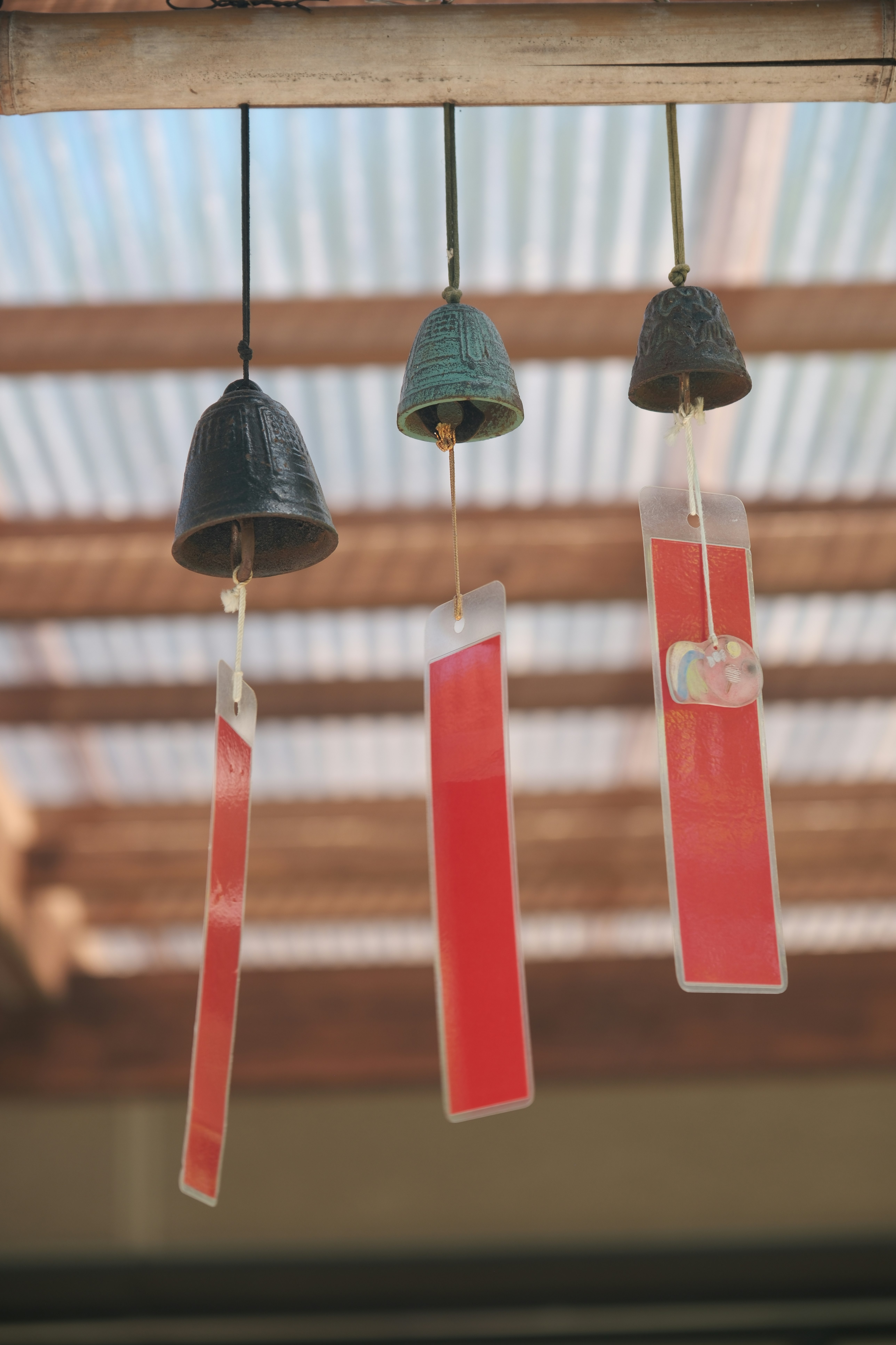 Chuông gió đỏ và những chiếc chuông treo trên dầm gỗ