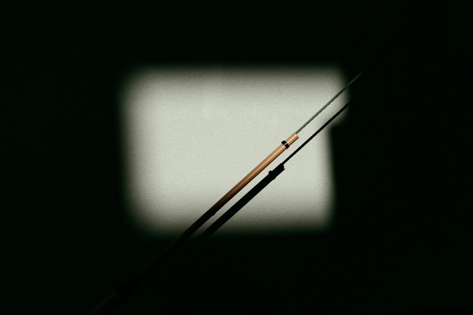 Two needles crossing in a dark environment with light shining through