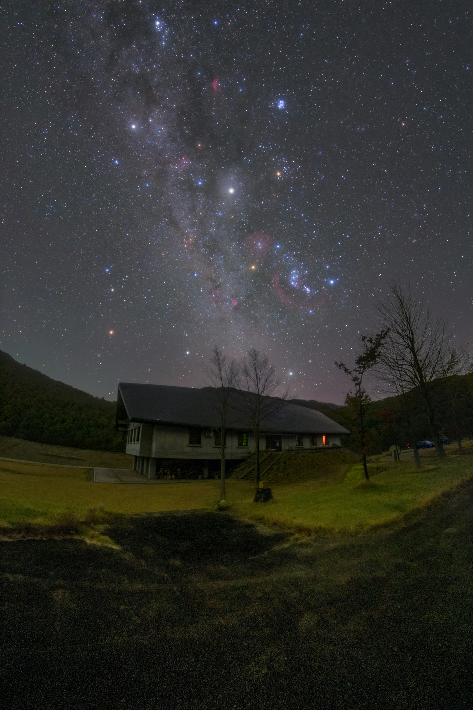 Una casa sotto un cielo stellato con la Via Lattea visibile