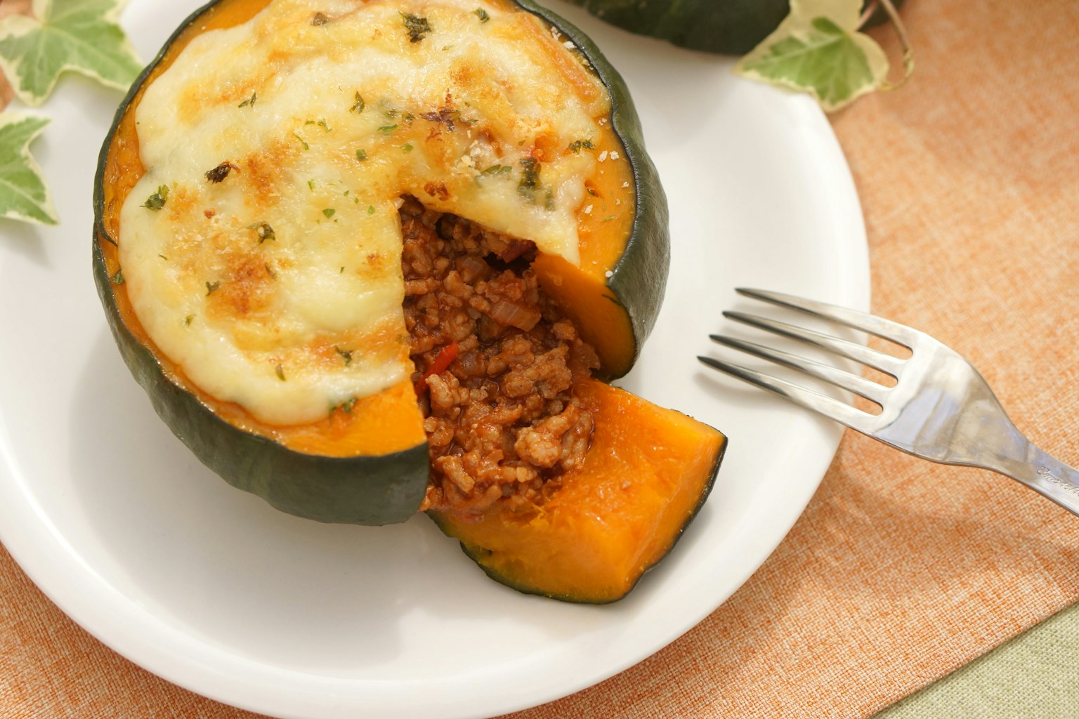 Stuffed acorn squash served on a plate with a fork