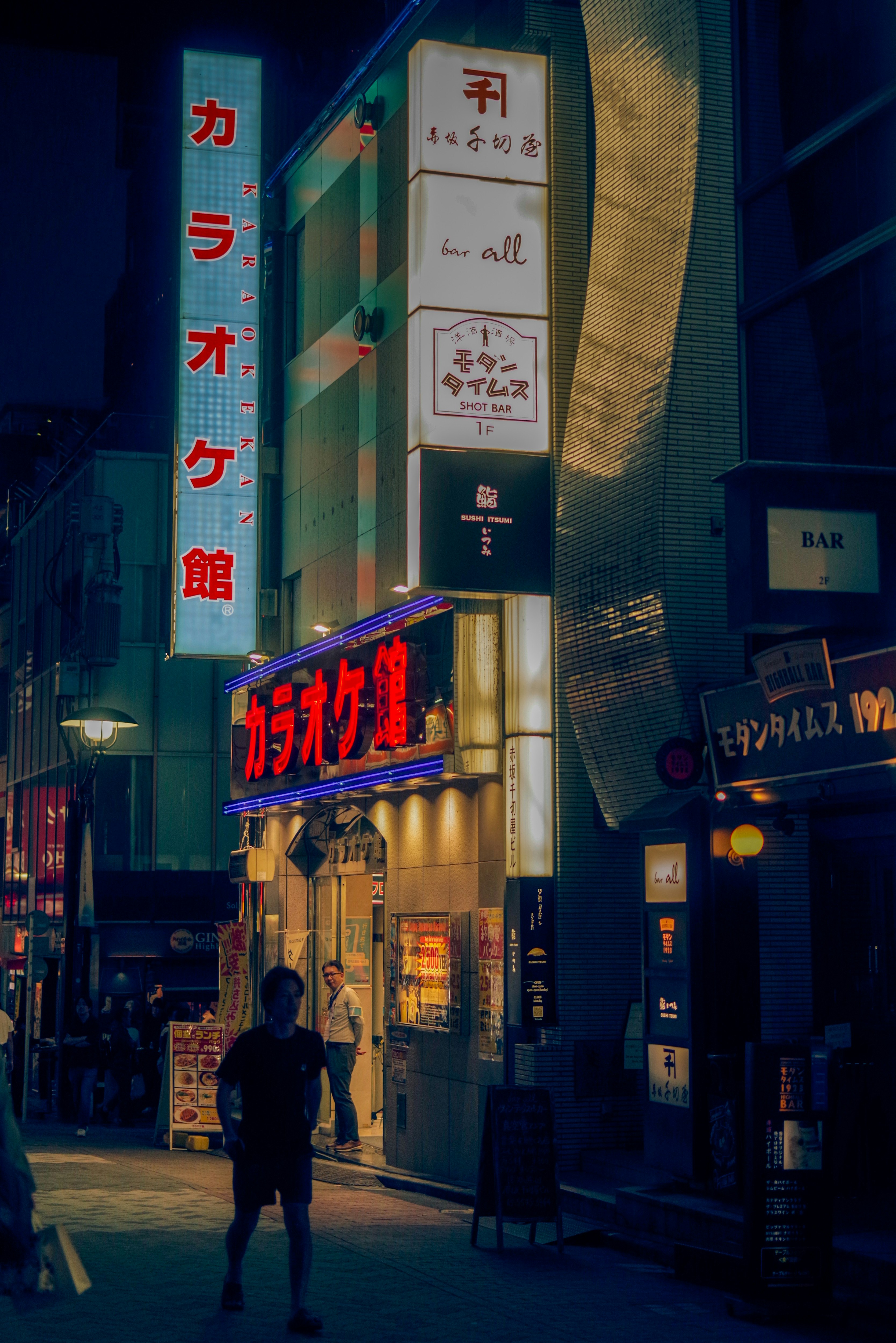 night alley with stacked shop signs and neon lights