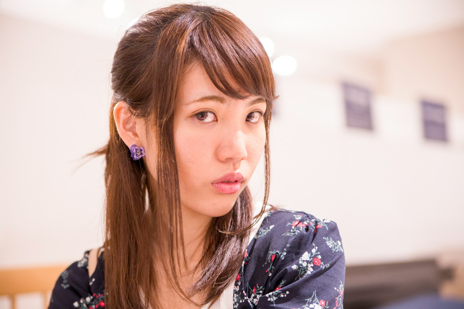 Portrait of a young woman with a side profile and floral dress