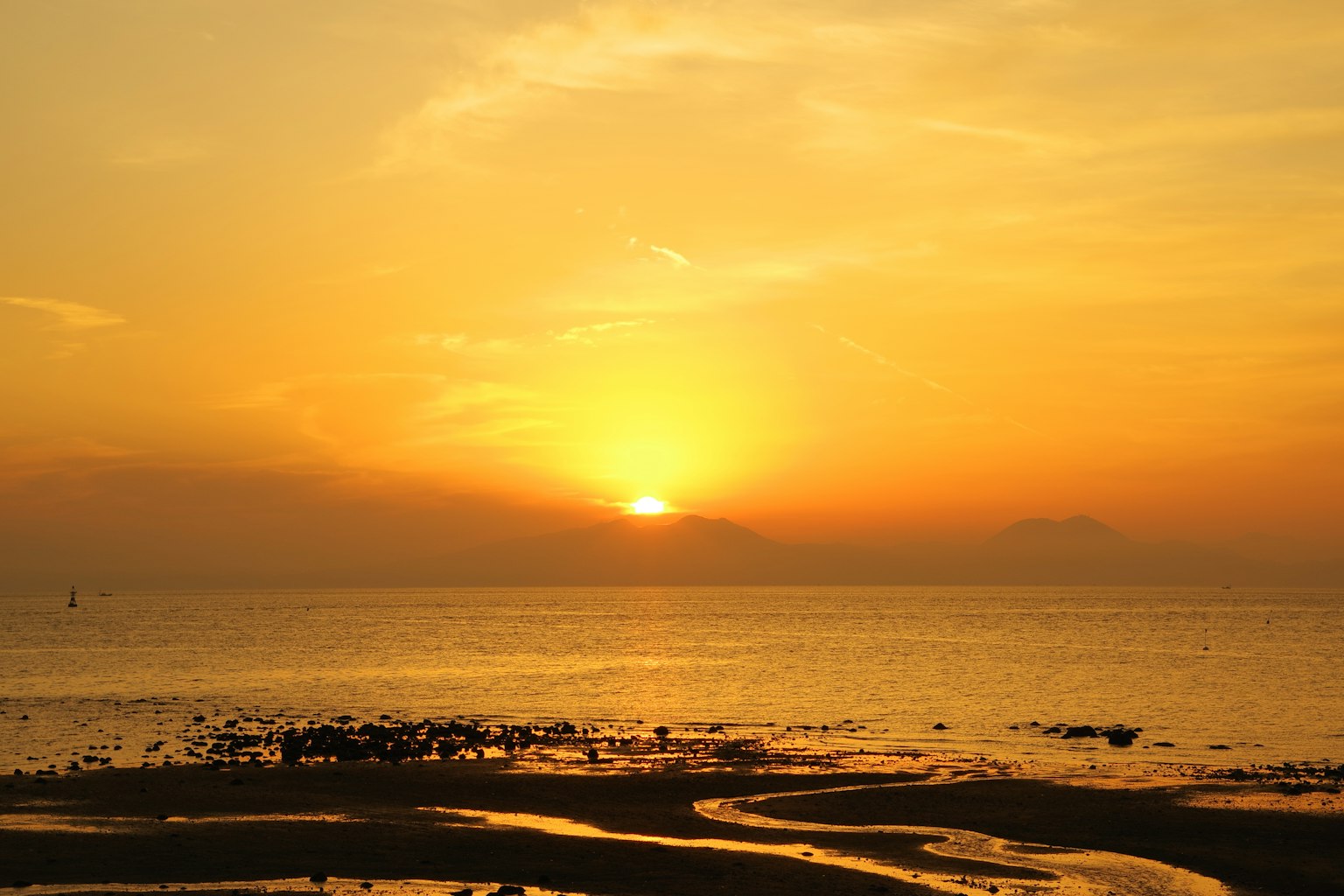 Sunset over the sea with orange and yellow sky