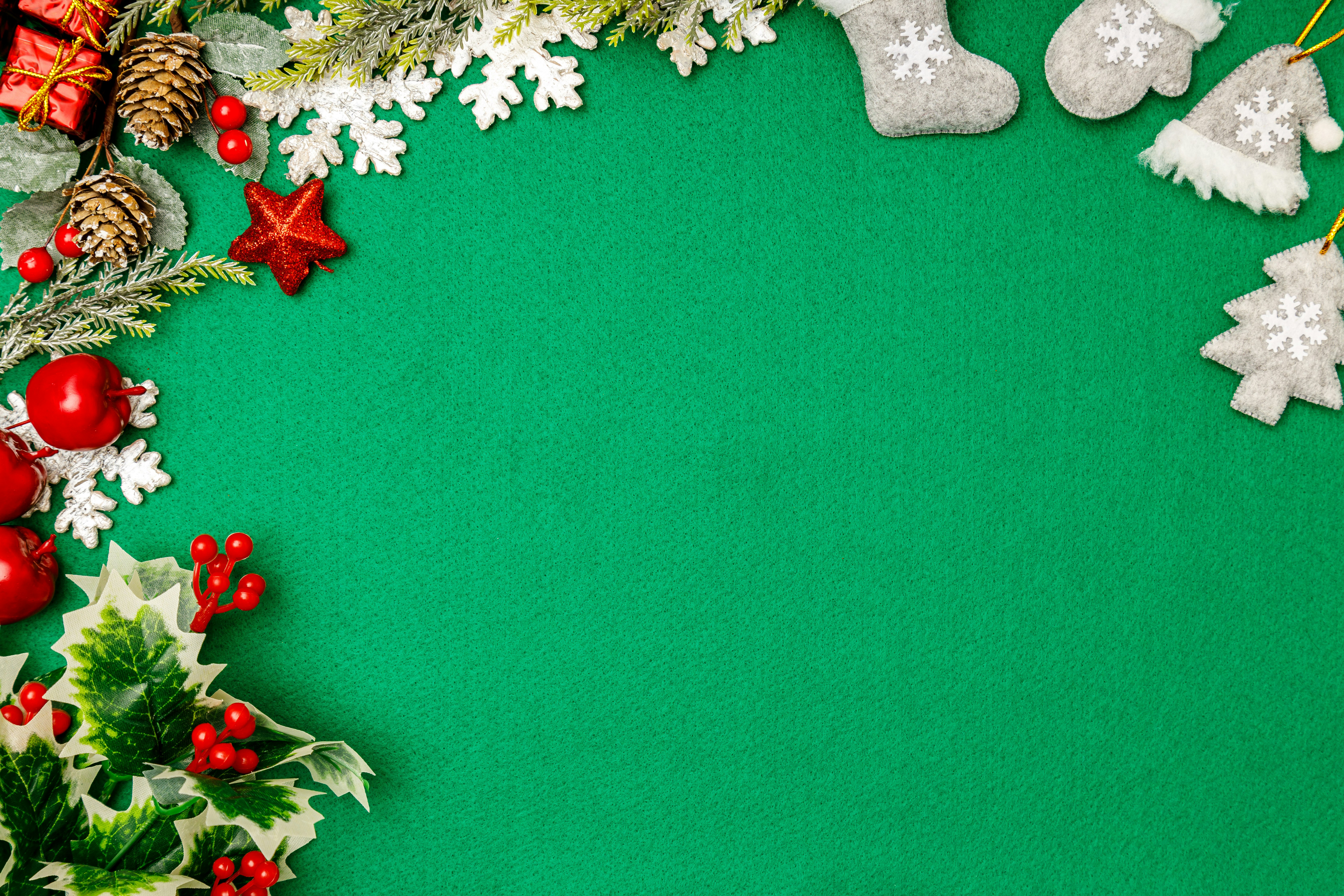 Christmas ornaments and snowflake decorations on a green background