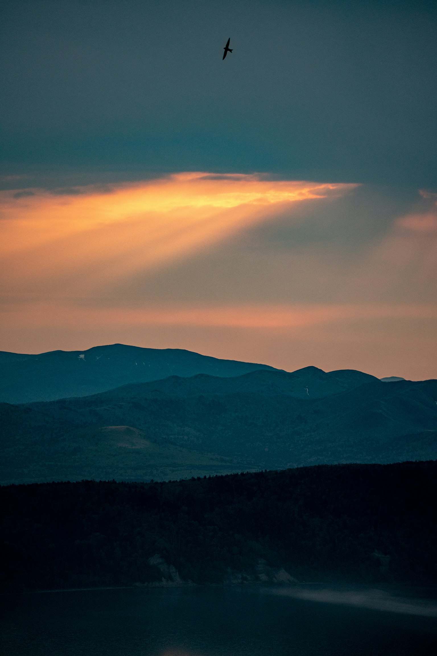 Silhouette von Bergen unter einem dunklen Himmel mit Wolken