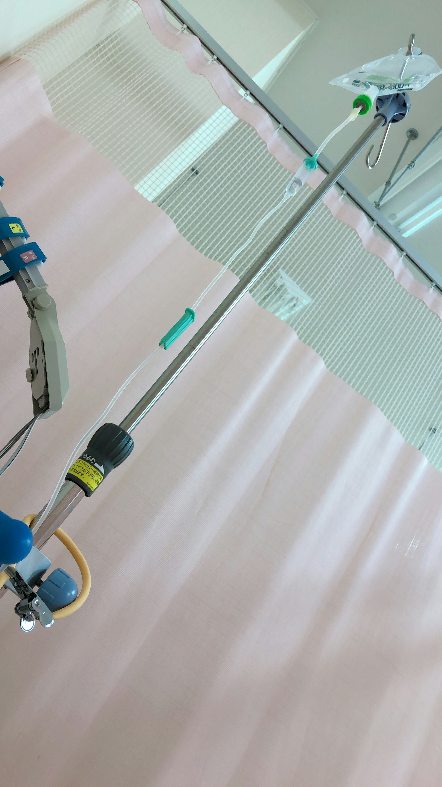IV stand in a hospital room with a curtain