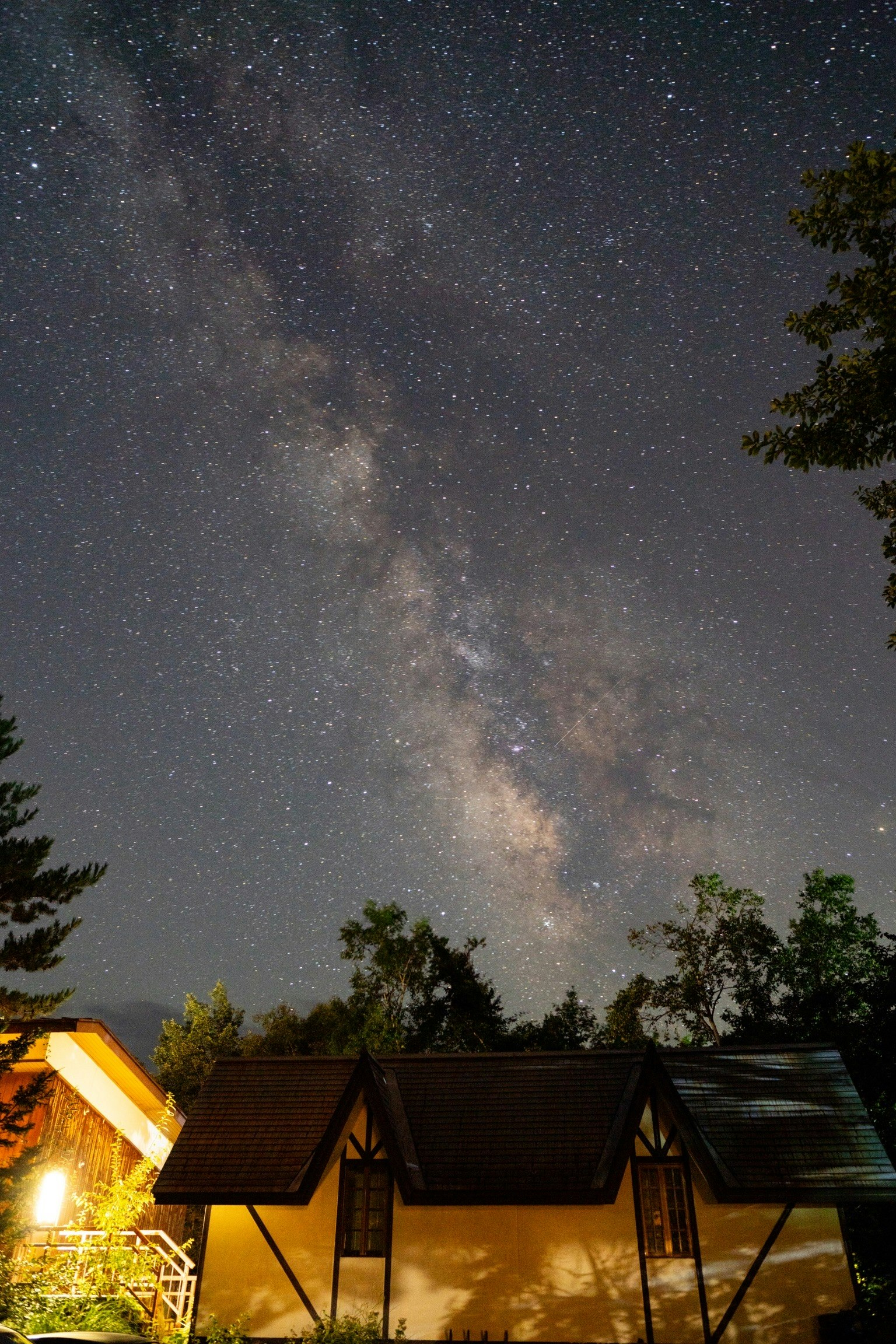 Milky Way over Norikura Kogen night sky with mountain lodge lights