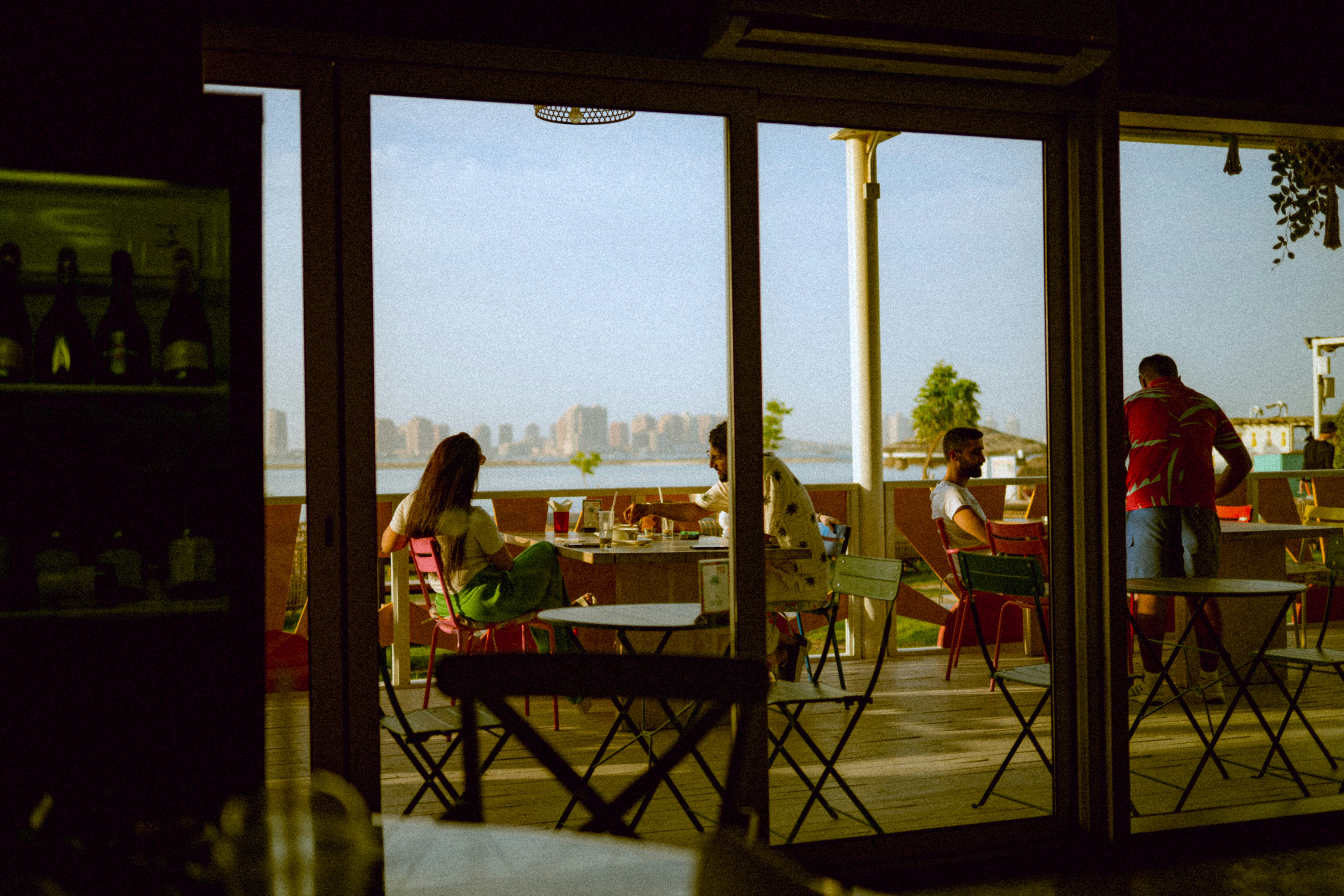 window view of an outdoor cafe seating area at dusk