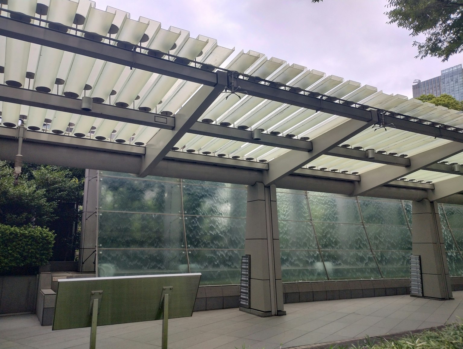 Modern architectural pergola with glass wall in outdoor space