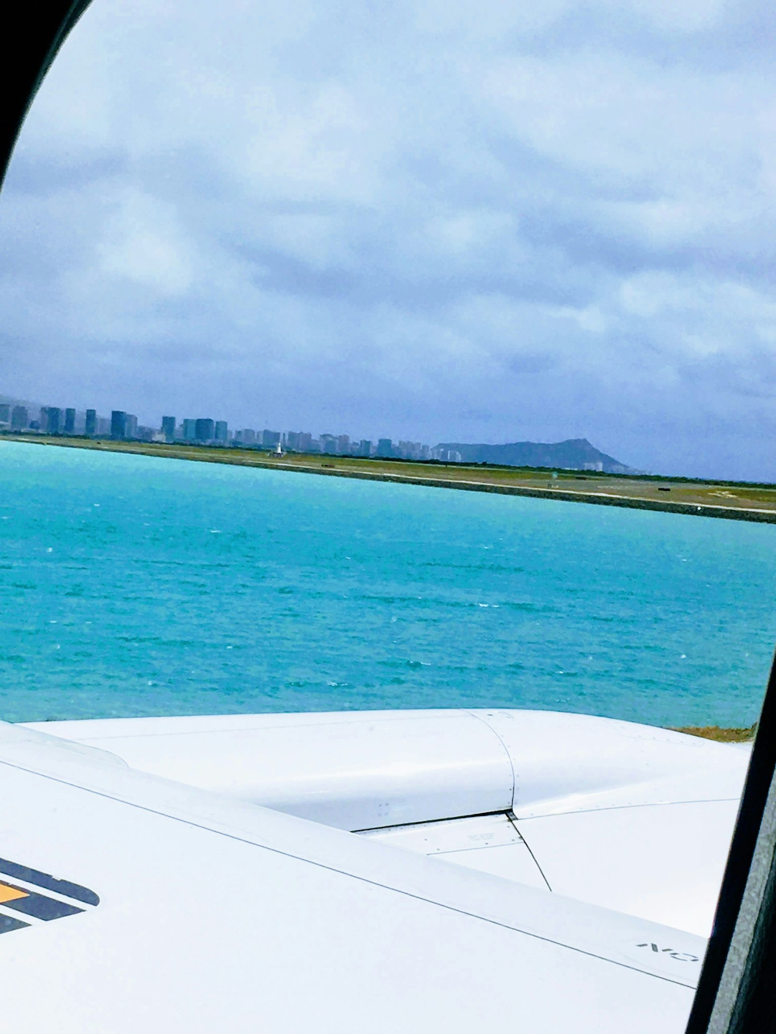 Vue aérienne de l'eau turquoise et de la ligne d'horizon de la ville près de l'aéroport