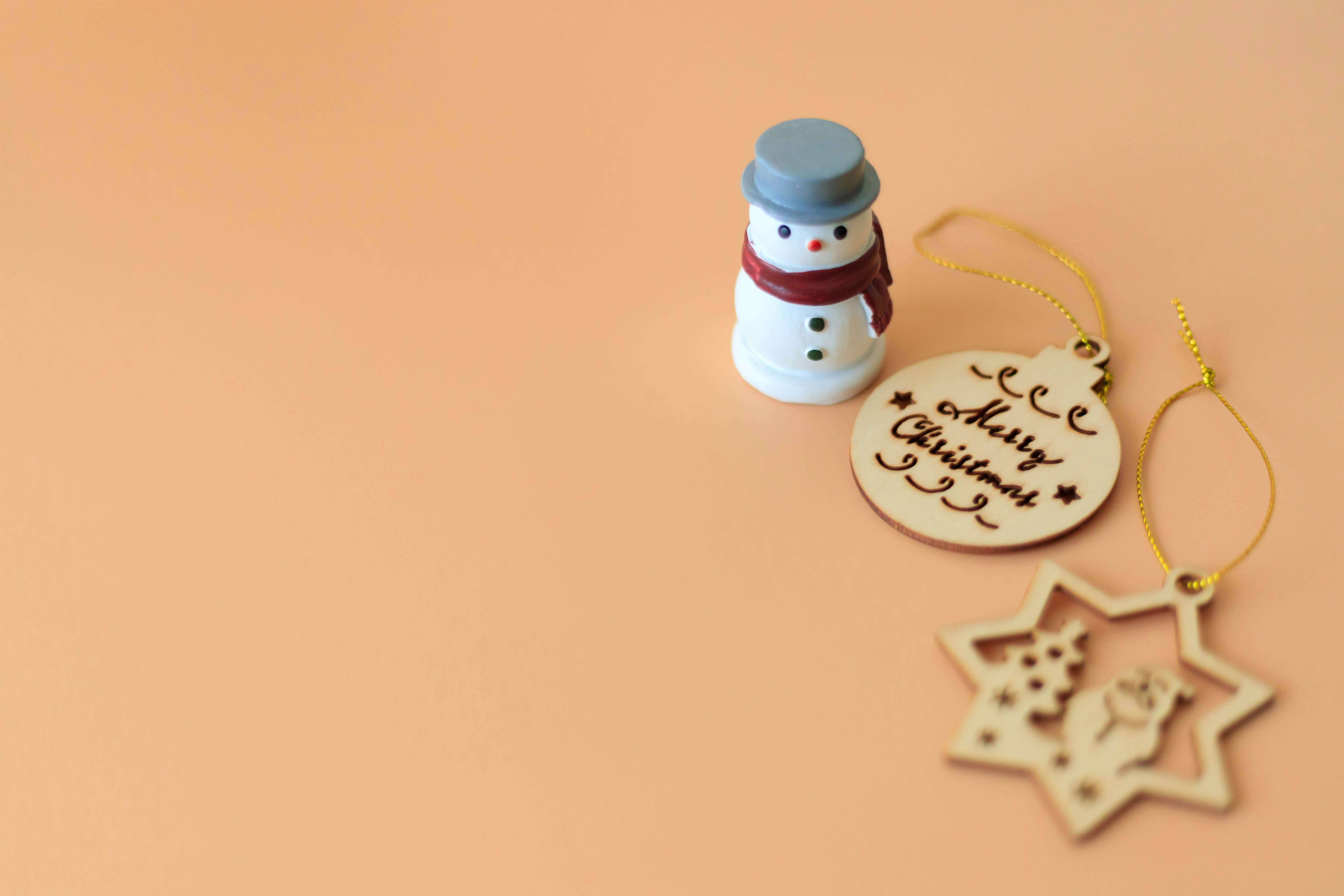 オレンジ背景のクリスマス飾りと雪だるまチャームの小物