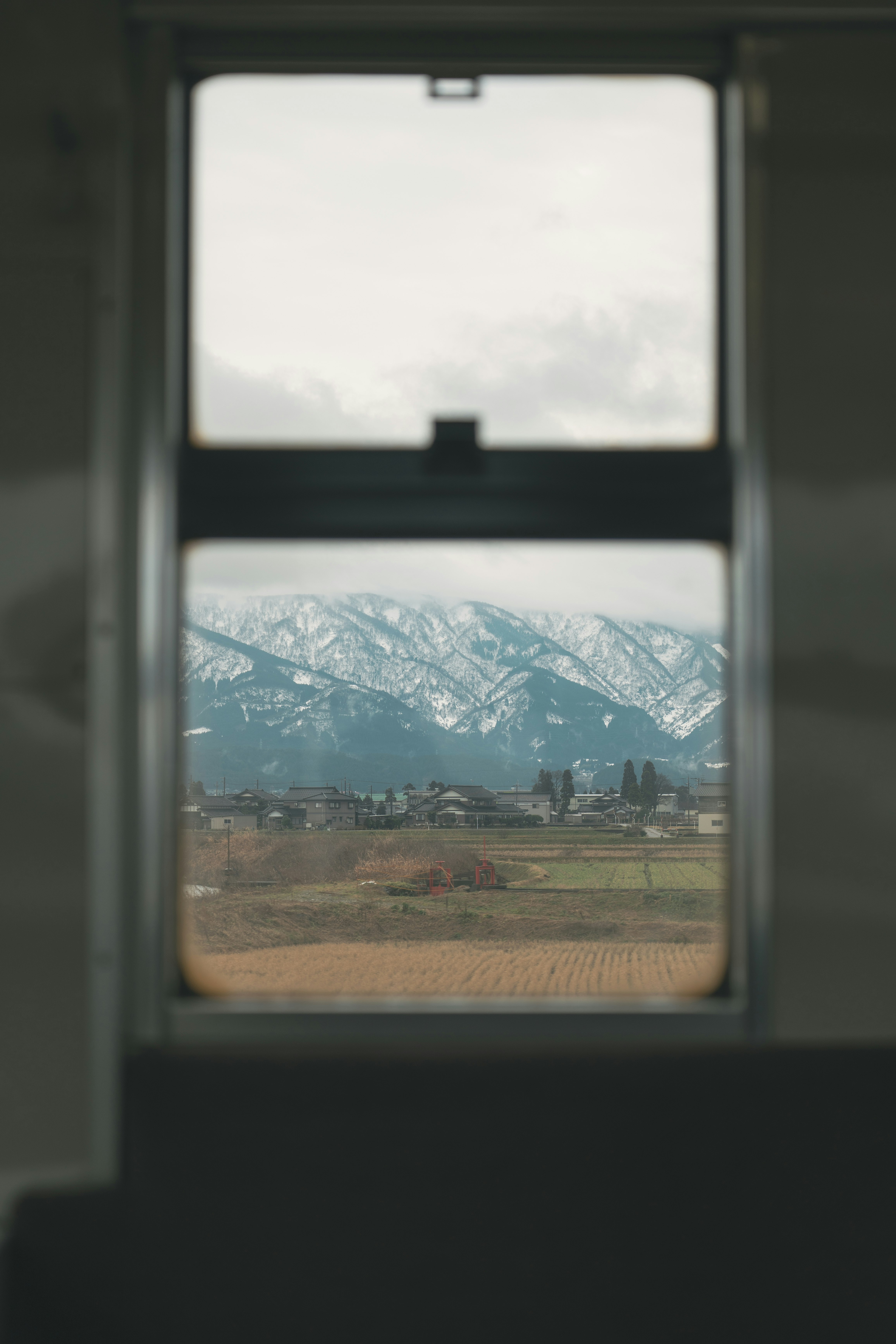 mountain range and countryside view through a window