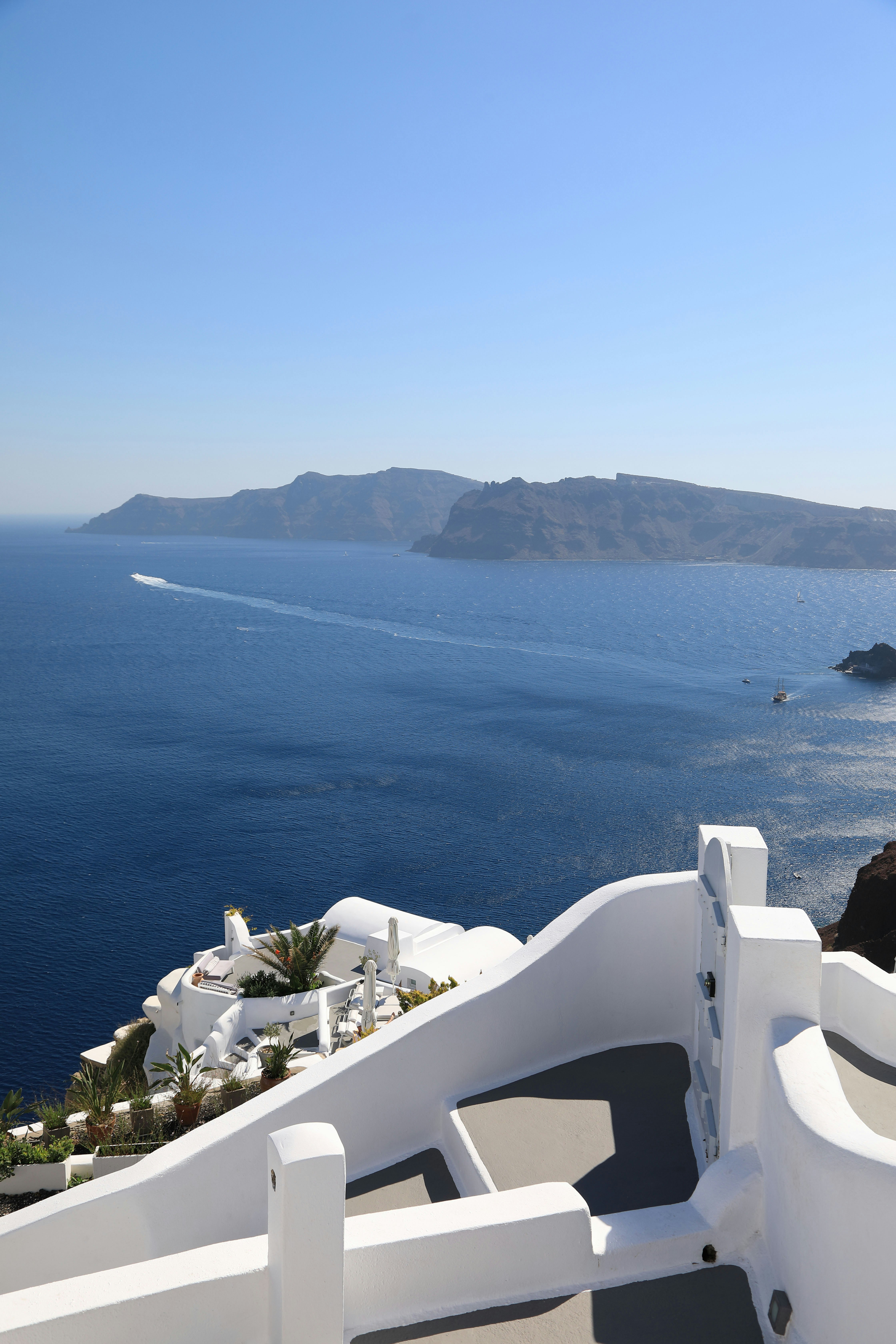 Santorini island viewpoint with white railing overlooking the blue sea