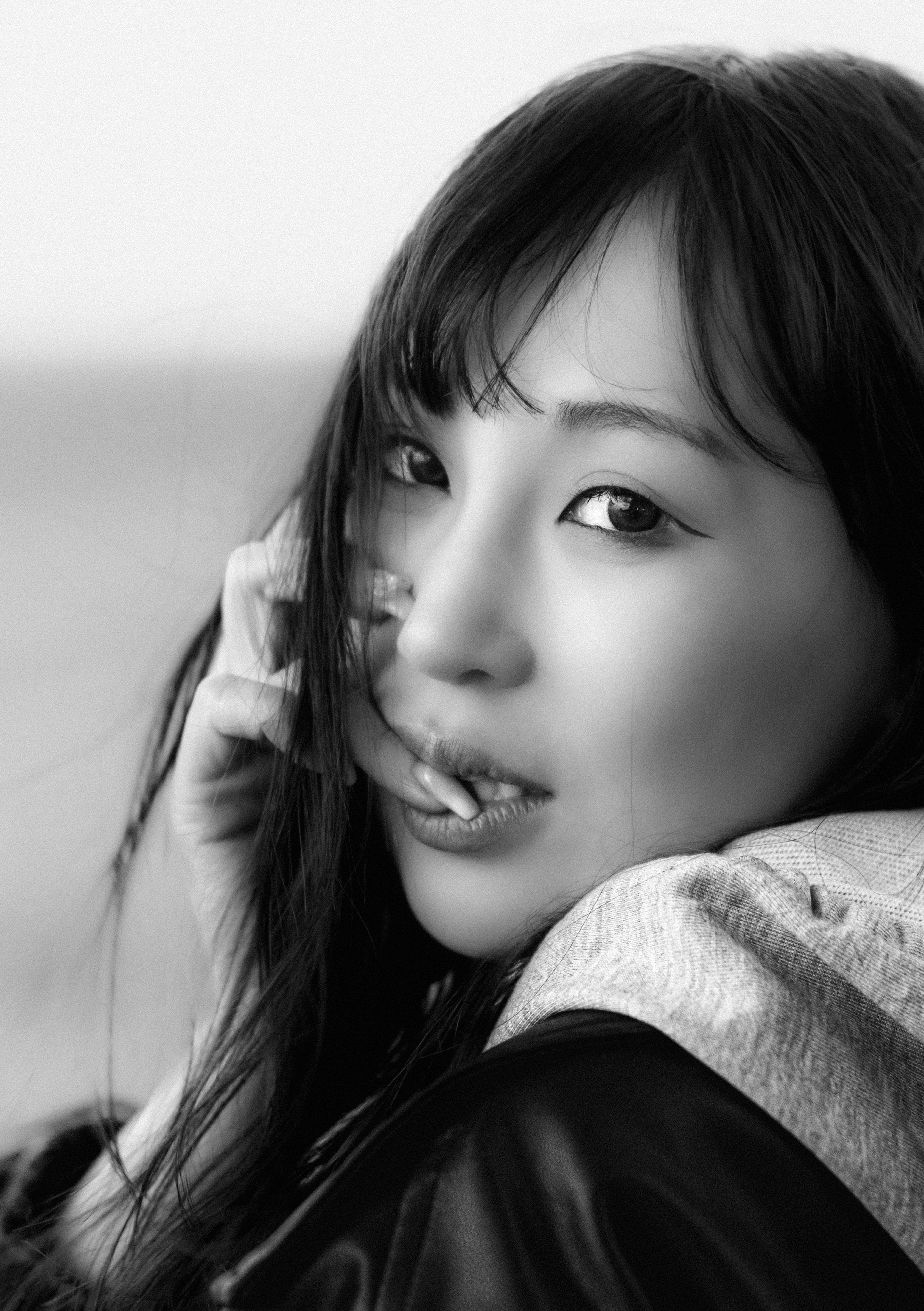 ソファに寄りかかるモノクロの女性のポートレート