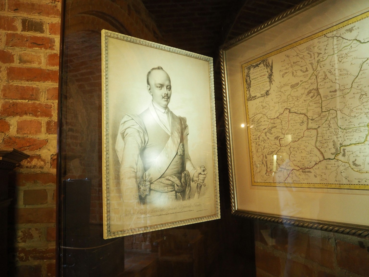 A historical portrait of a man alongside a detailed map