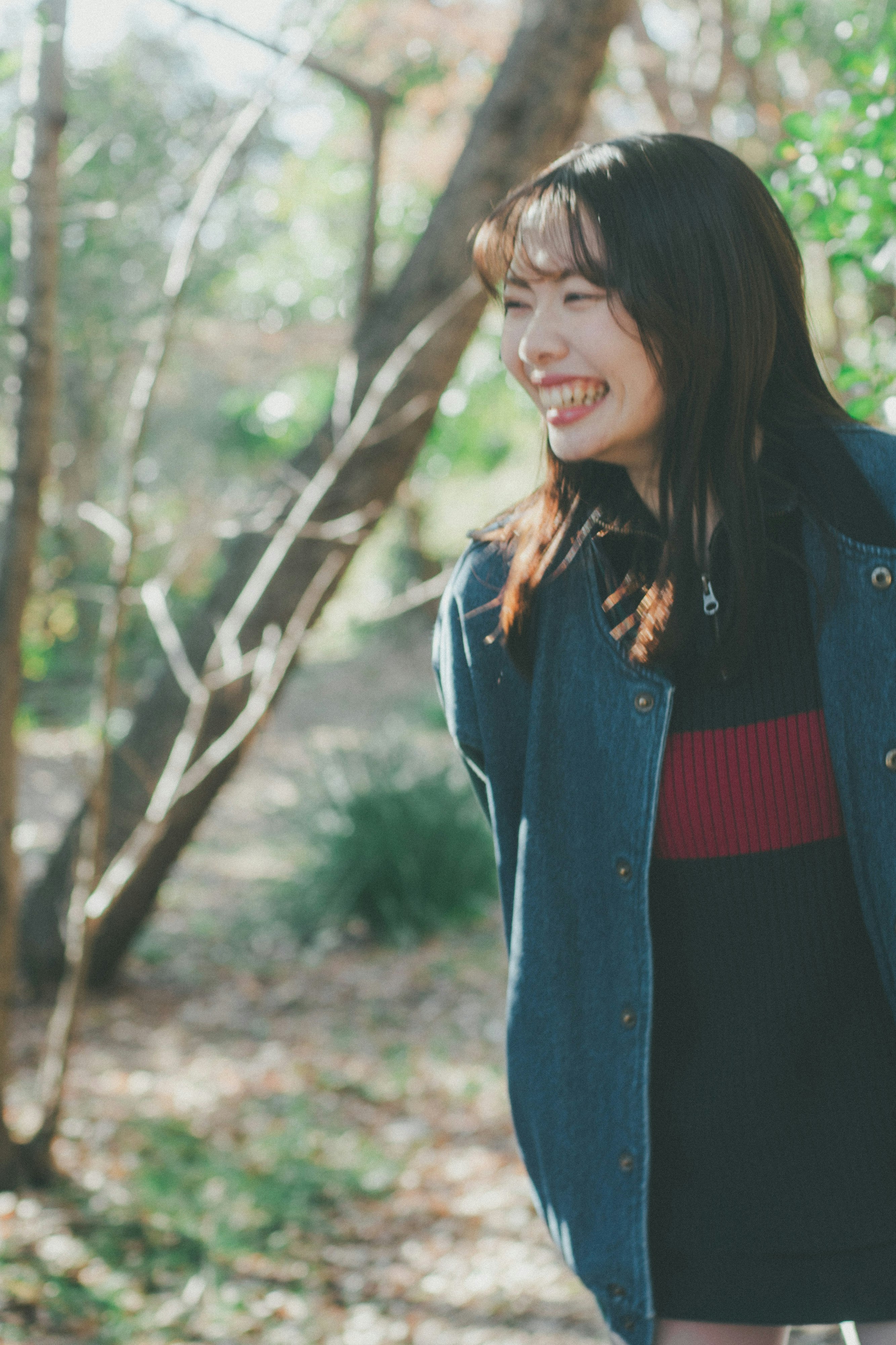 smiling woman on a forest path