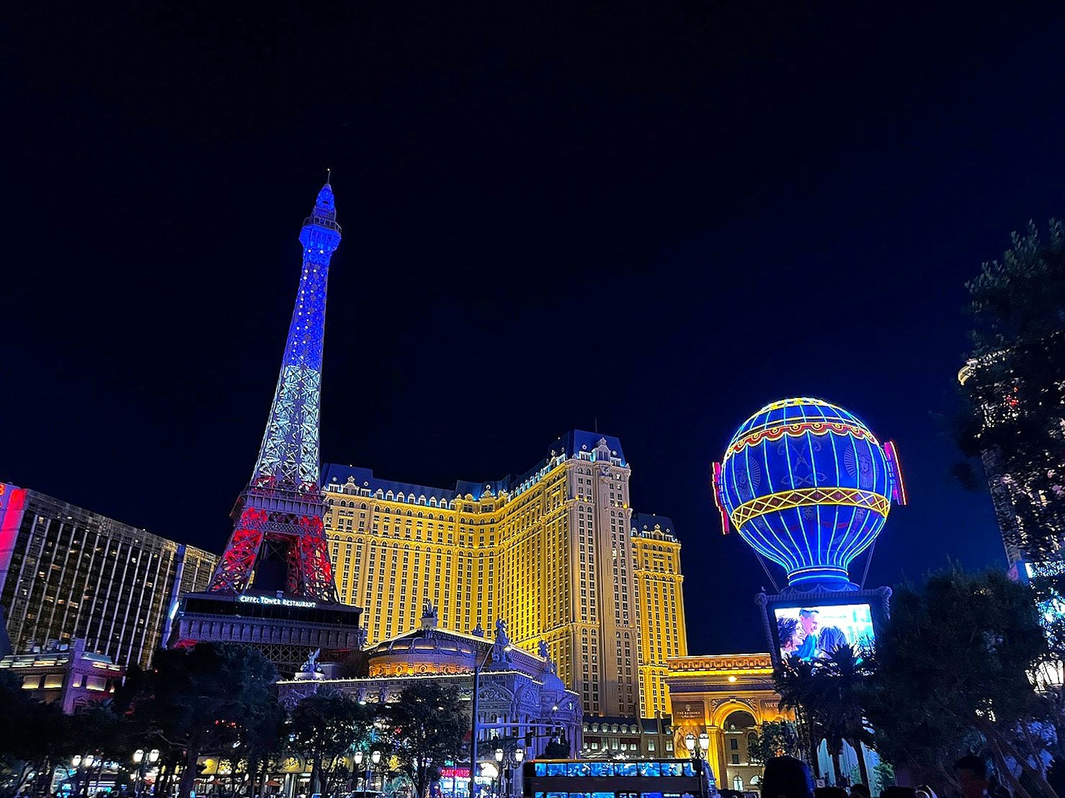 Nachtansicht von Las Vegas mit dem Eiffelturm und beleuchteten Casino-Gebäuden
