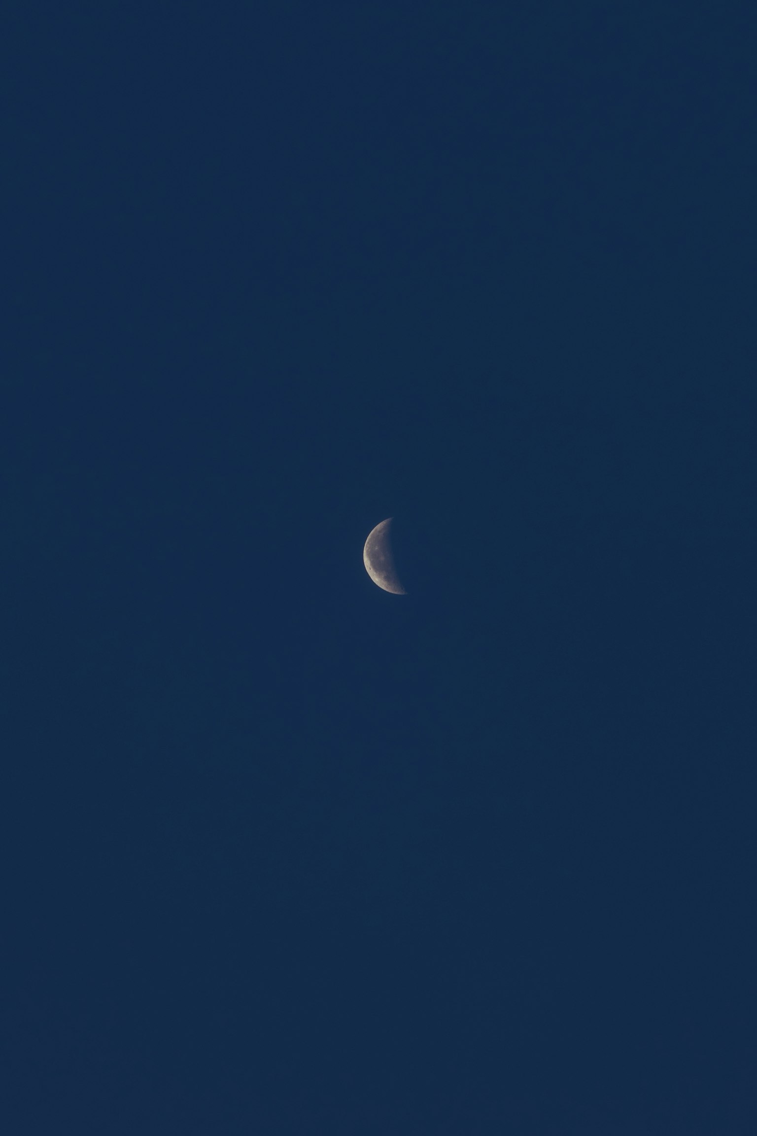 Crescent moon in a dark blue sky