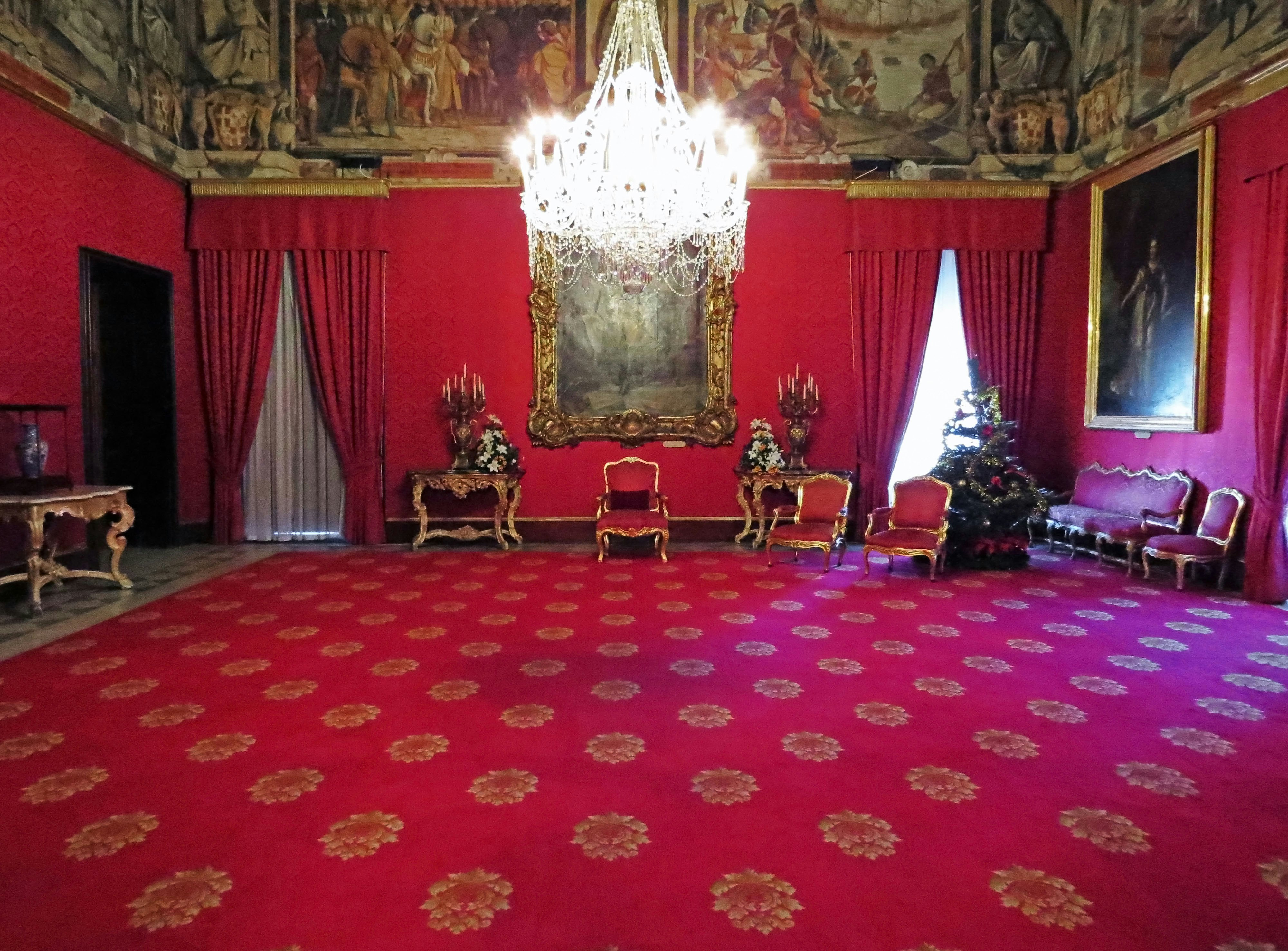 luxurious indoor hall with red curtains and a chandelier