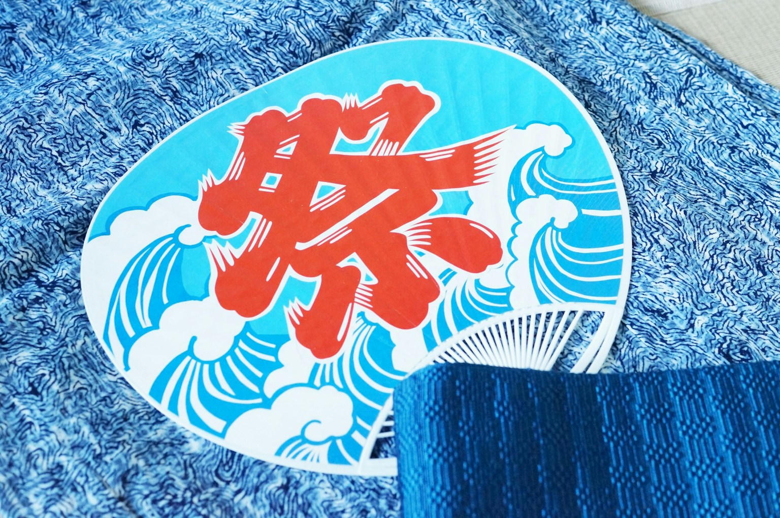 蓝色布料上有红色文字和波浪图案的圆形贴纸