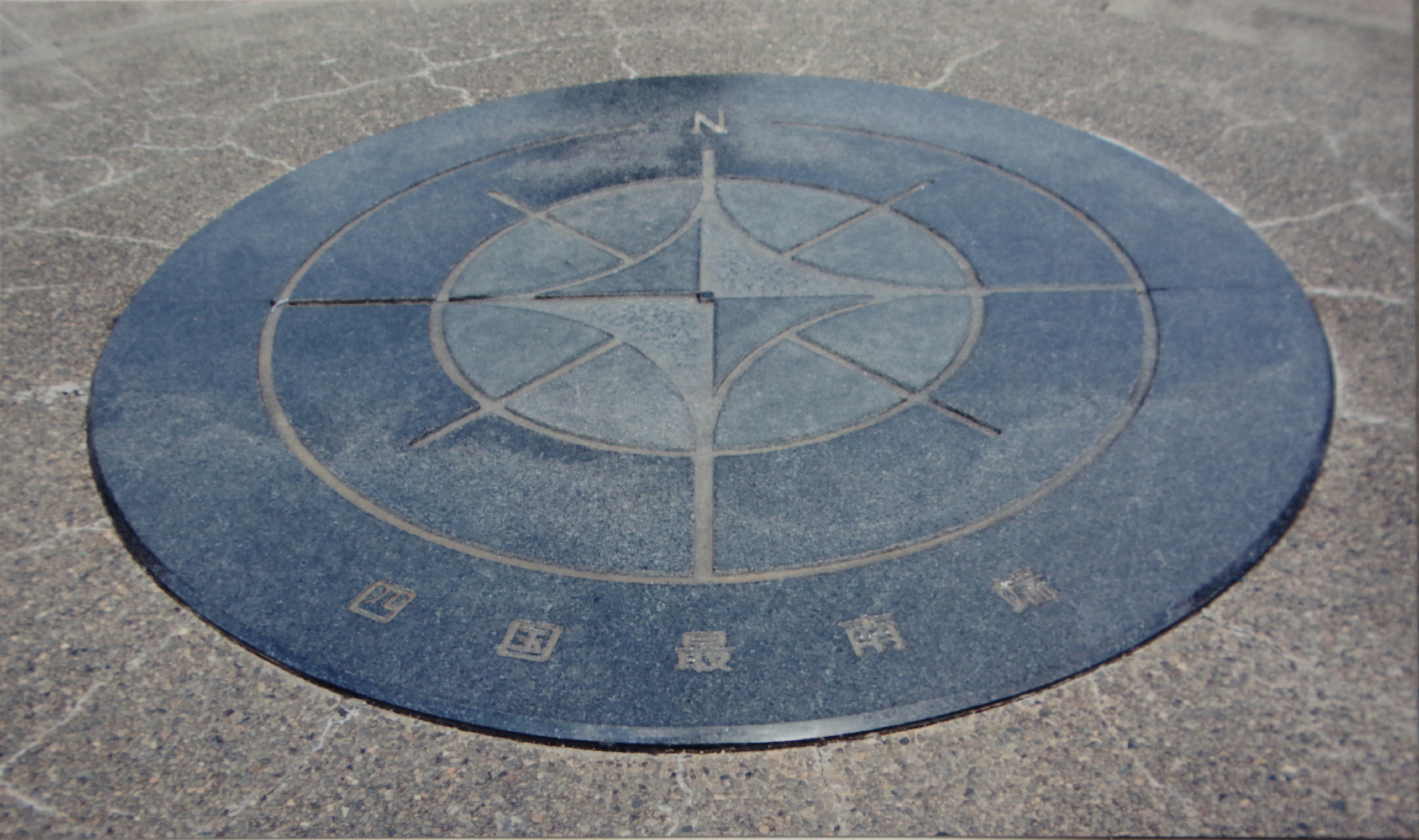 circular compass rose marker painted on the ground