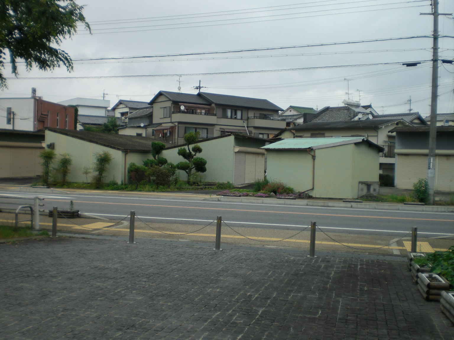 Quiet street view with old houses lined up visible greenery along the road