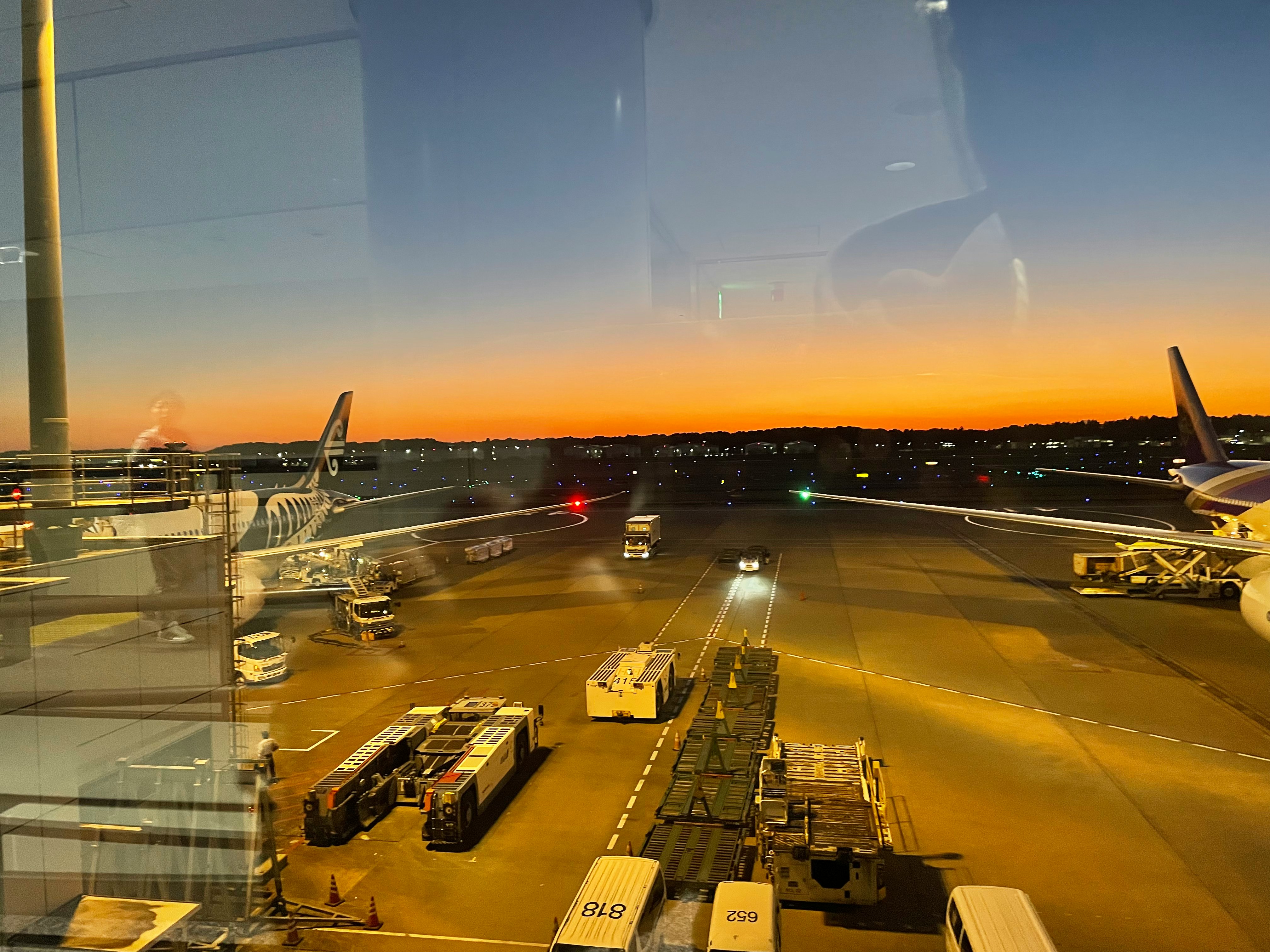airport runway and aircraft parking at sunset