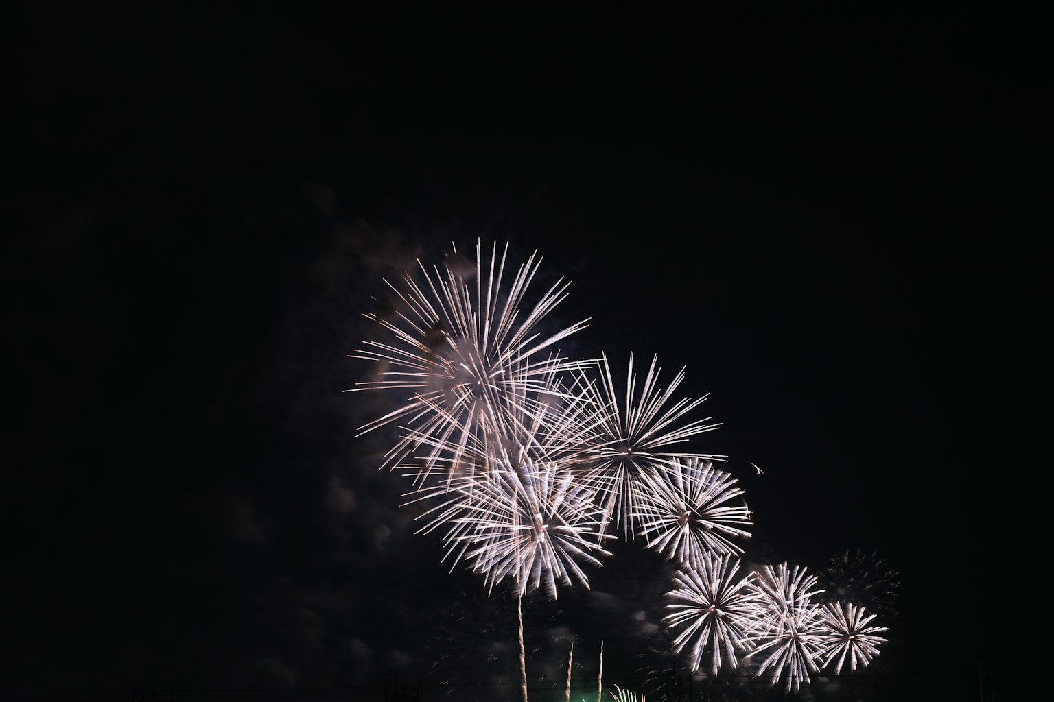 White bursts resembling fireworks in the night sky