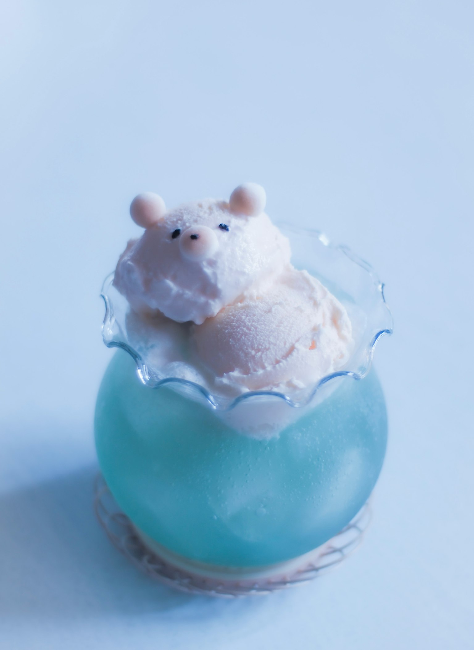 Dessert featuring a cute bear-shaped ice cream on top of blue jelly