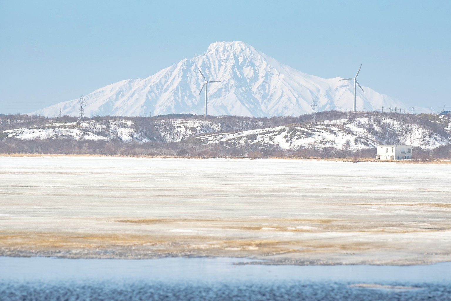 Snow-covered mountain with clear blue sky