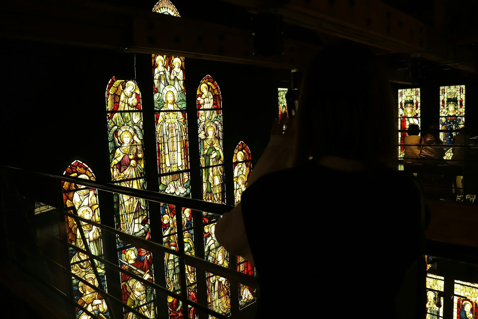 Person admiring beautiful stained glass windows