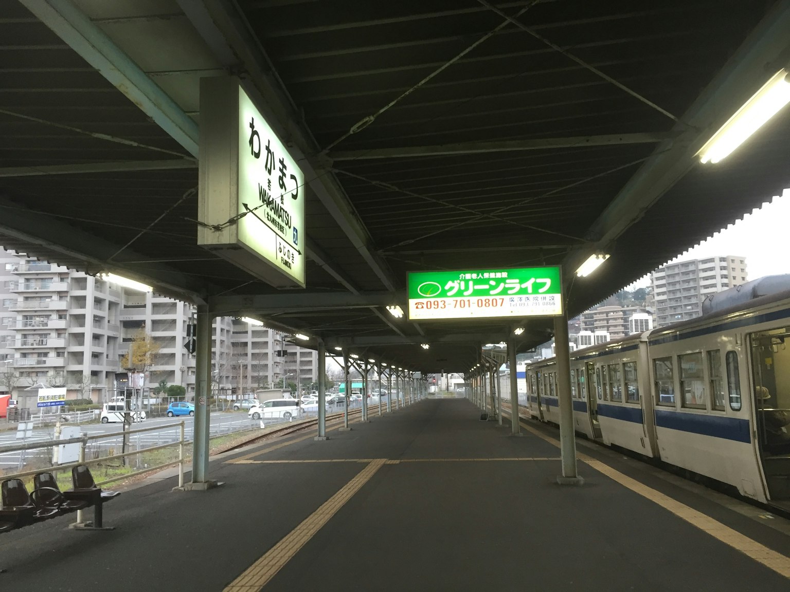 Train at a platform with signs in Japanese