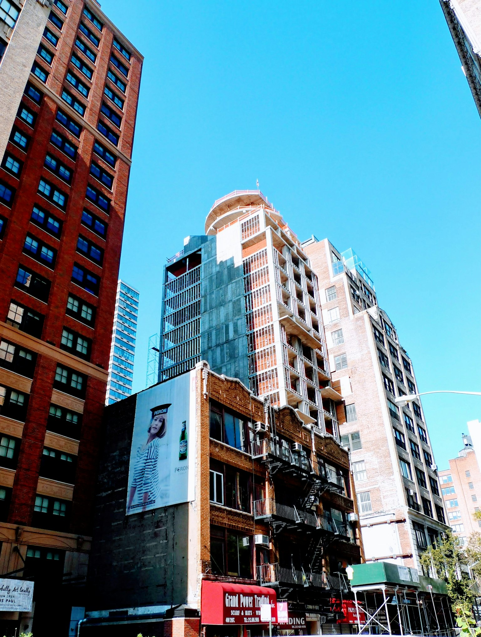 Urban skyline featuring a mix of modern and older buildings under a clear blue sky