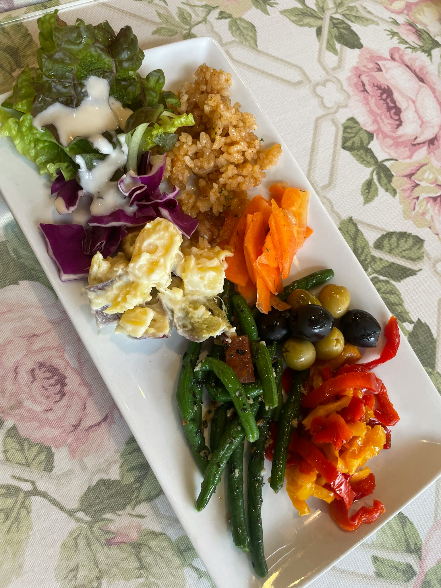 A plate featuring a variety of colorful vegetables and salad