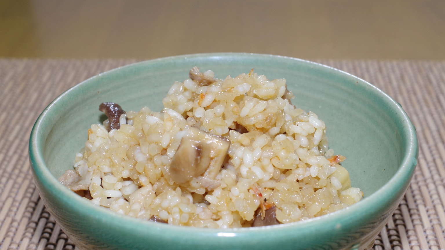Rice and mushroom dish served in a green bowl