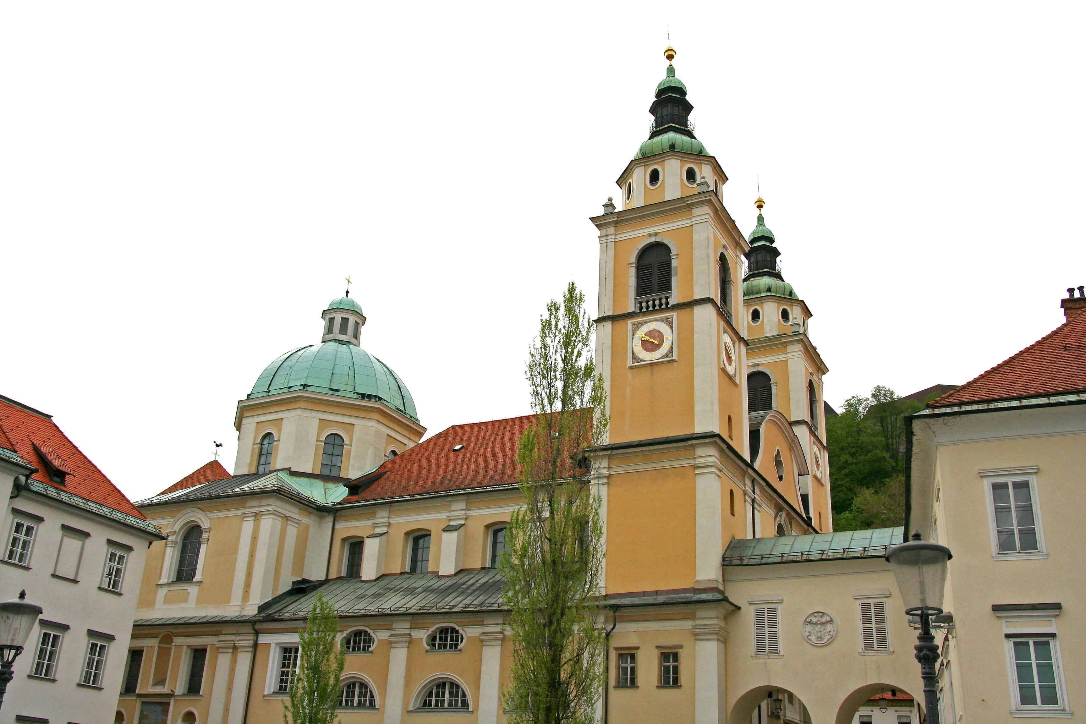 Yellow baroque church building with domed roofs