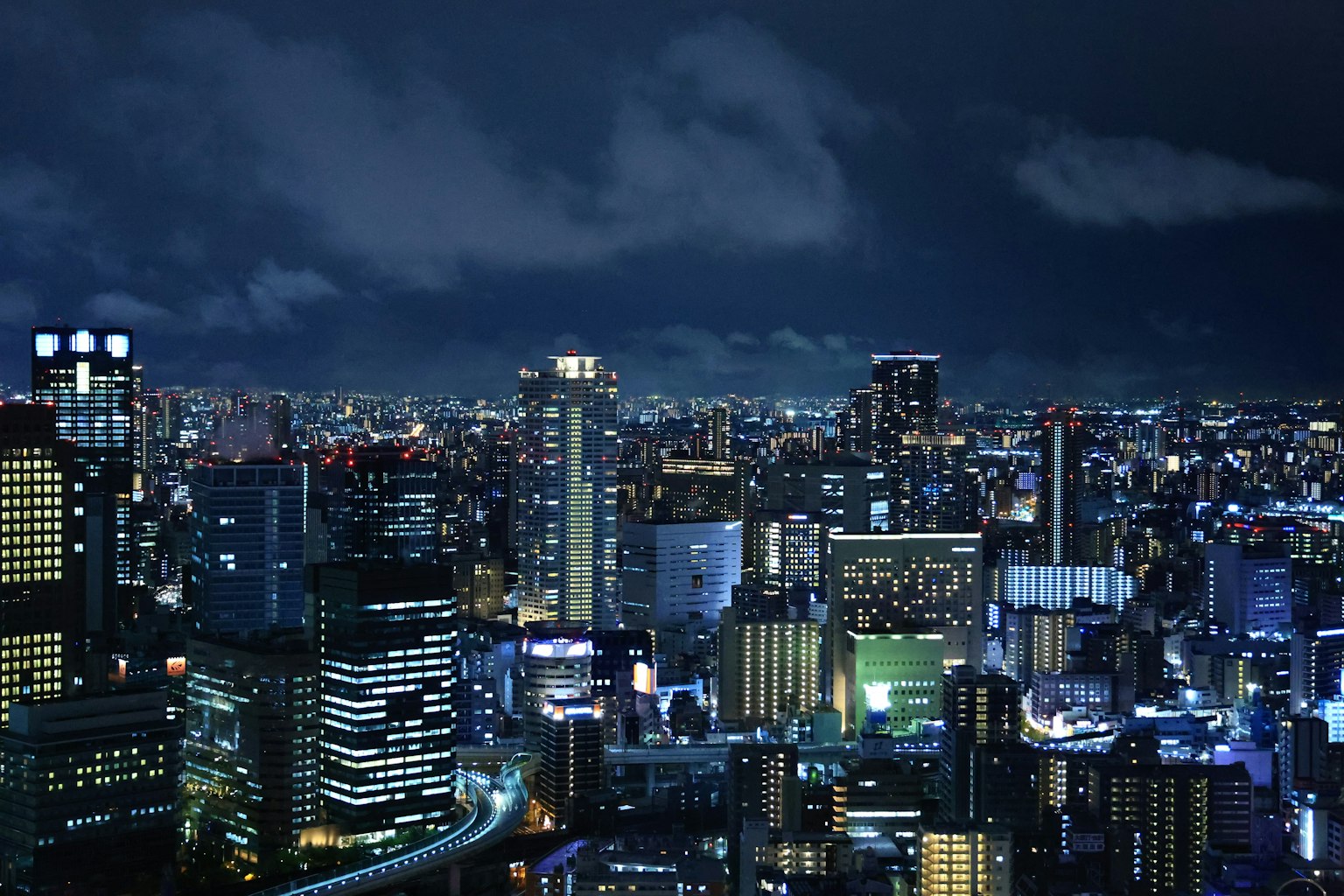 Pemandangan kota Tokyo di malam hari dengan lampu terang dan gedung pencakar langit