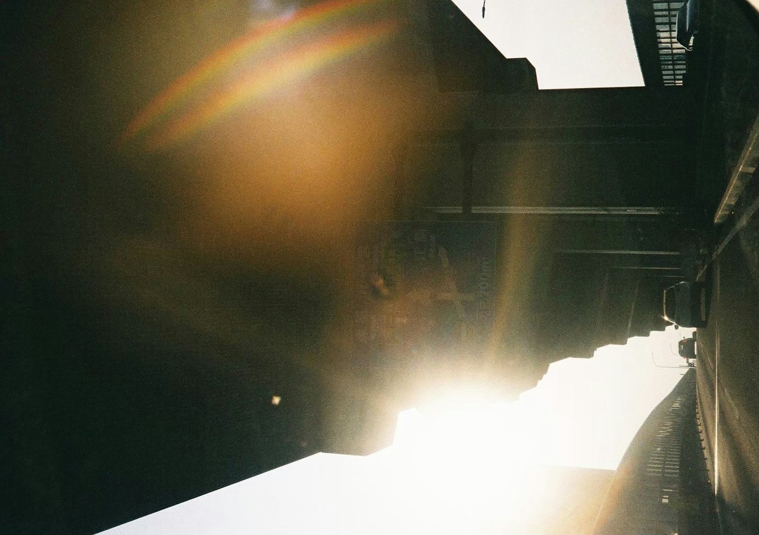Urban scene with sunlight streaming between buildings at sunset